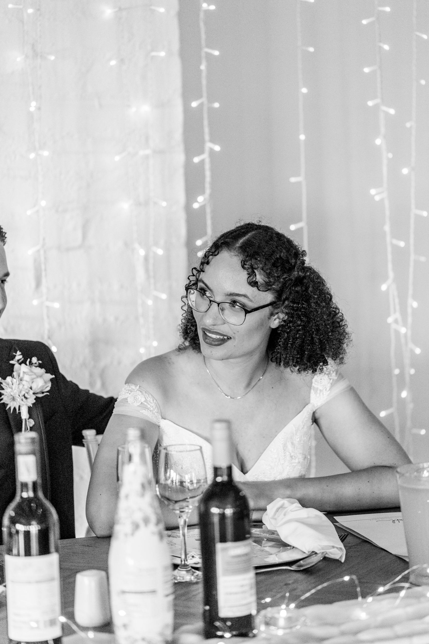 Three candid dining photos with string lights in background show a casual celebratory meal setting.