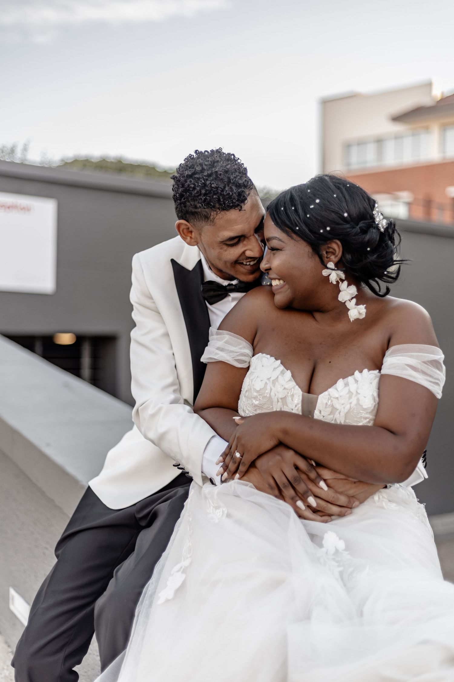 A couple sharing intimate moments in formal wedding attire against a light background in three sequential photos.