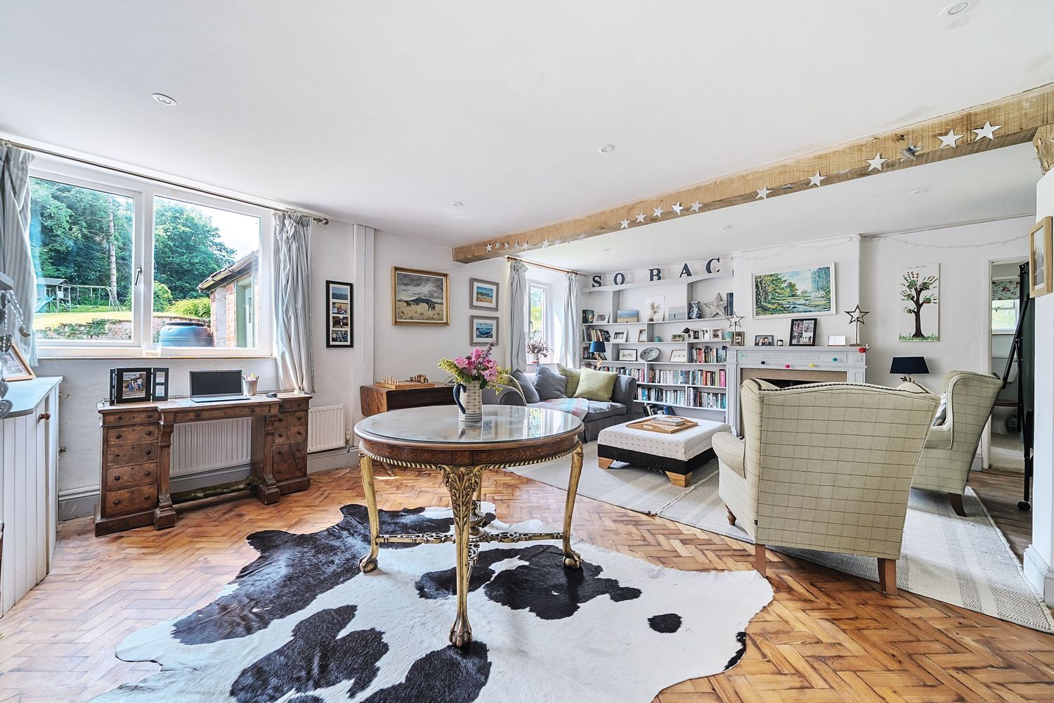 High resolution panoramic interior view of a modern open floor plan living space with hardwood floors and natural light.