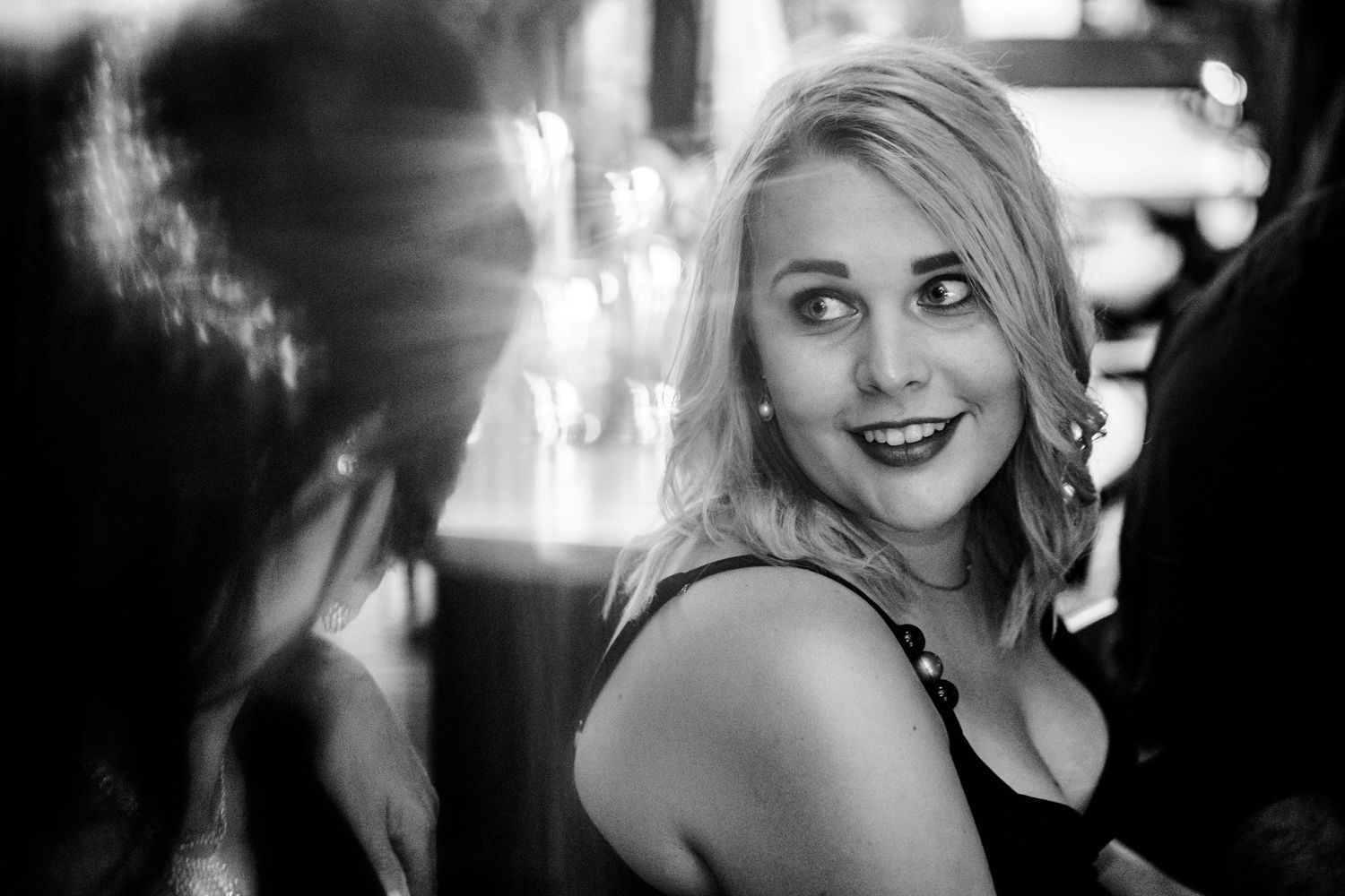 A series of black and white candid expressions shown in a filmstrip style layout capturing joyful moments.