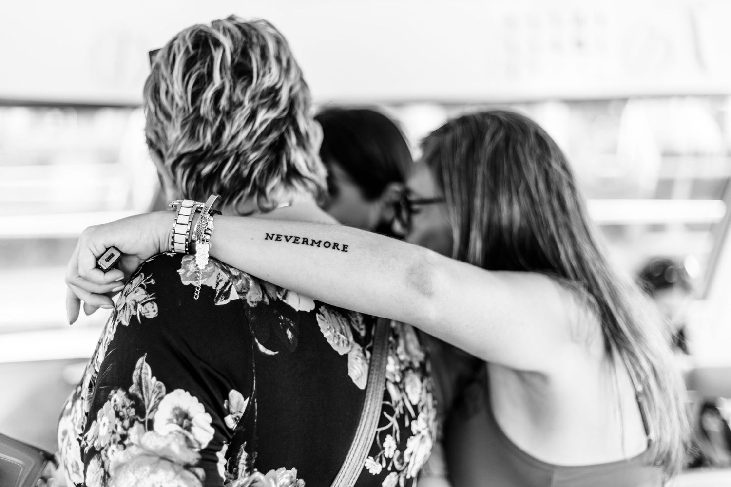 Group of wedding guests dancing and celebrating during a black and white reception party moment.