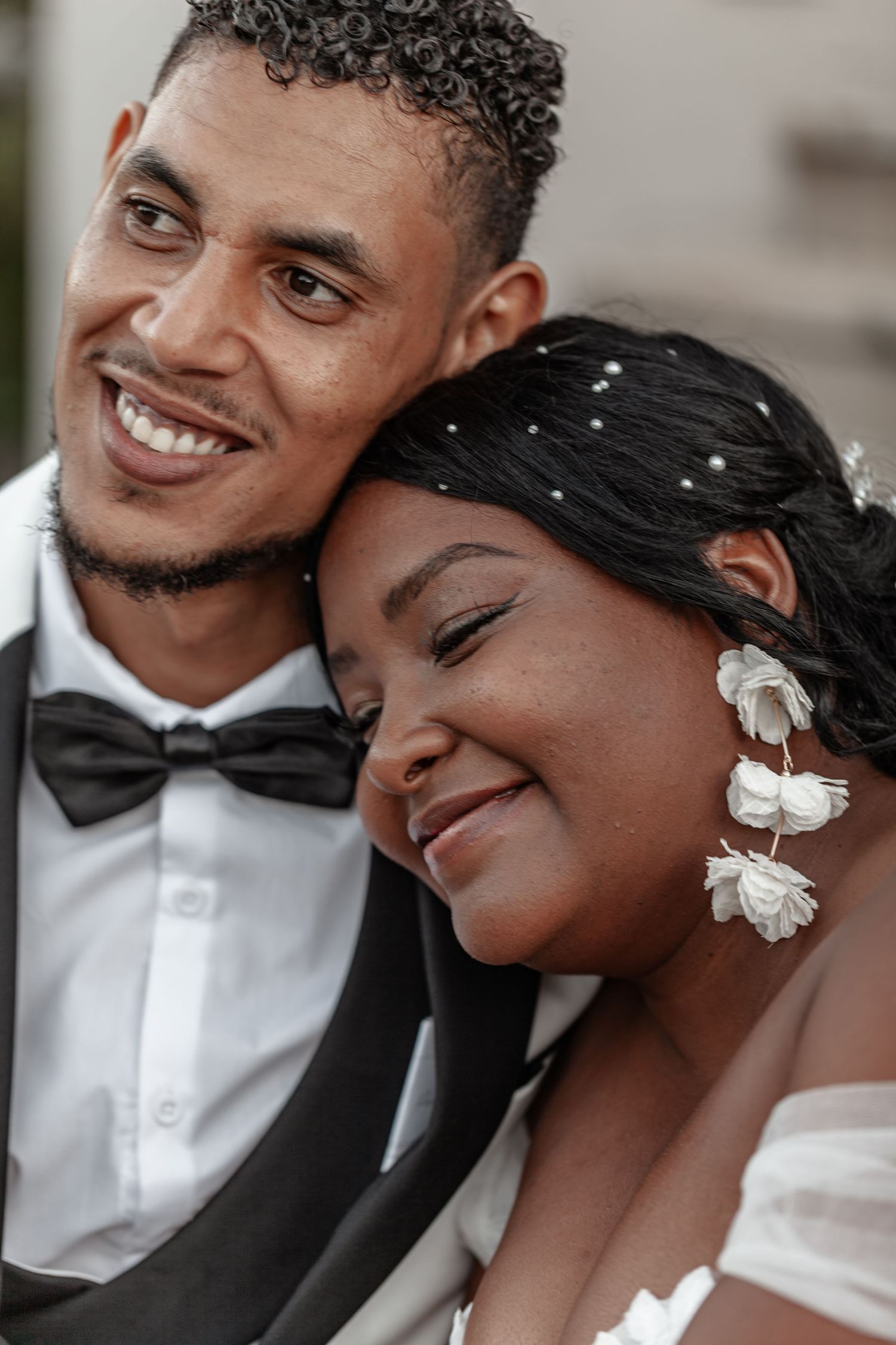 A tender candid wedding moment captured in an intimate portrait outdoors.