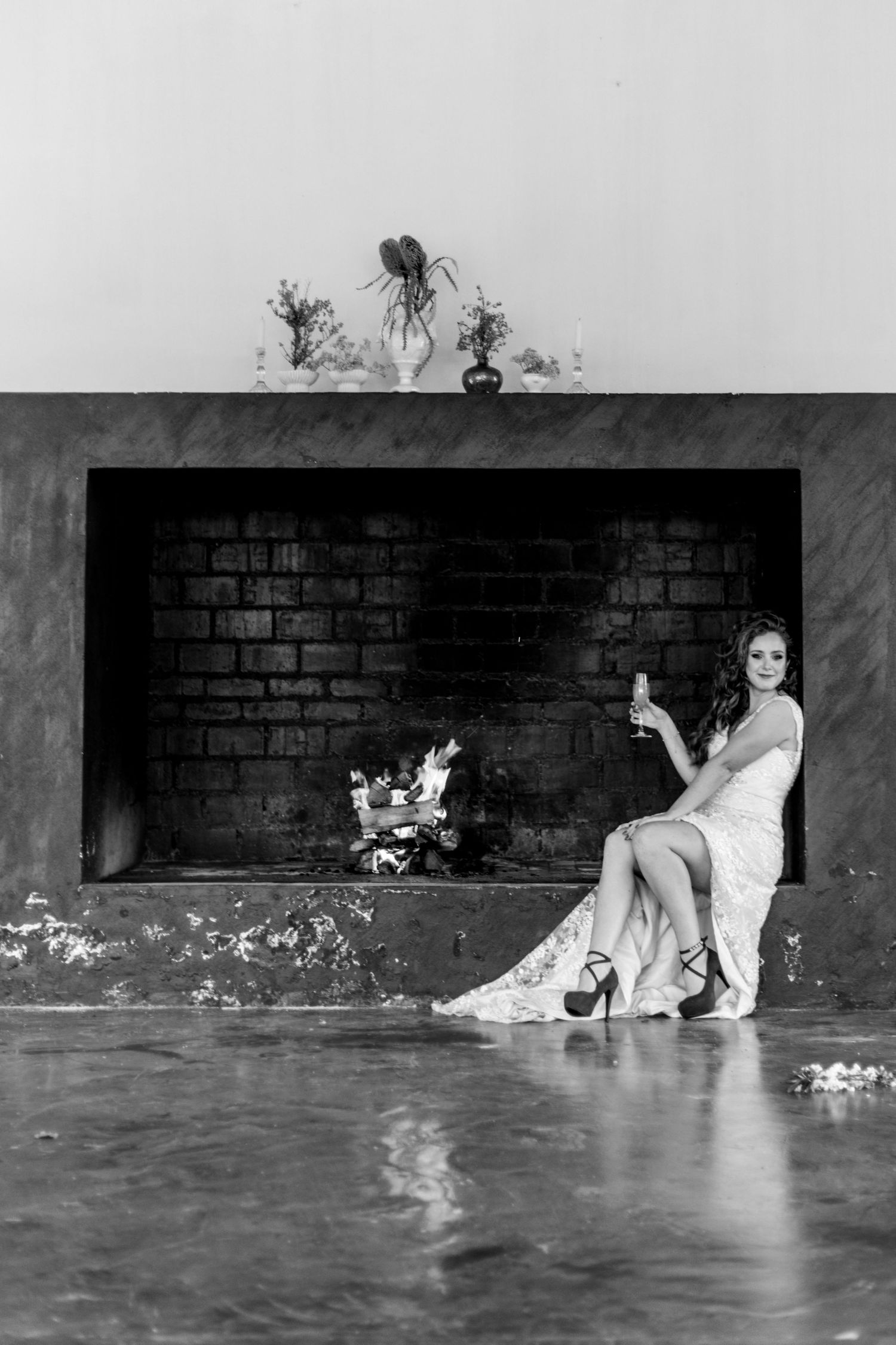 A sequence of black and white photos showing flood waters progressively rising around two people against a brick wall.
