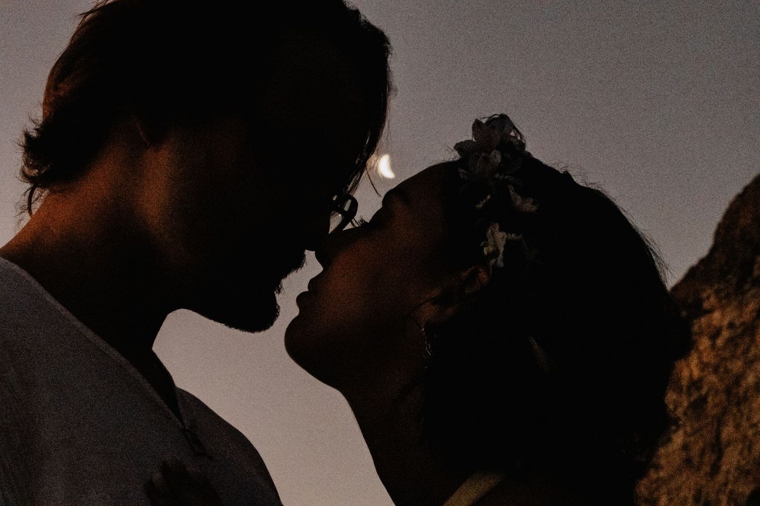 A cinematic black and white image sequence shows intimate silhouettes of a couple in romantic poses.