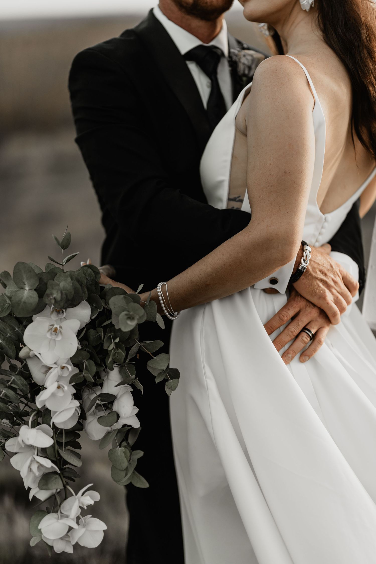 A romantic wedding photo series showing close-up details of a couple in formal attire with white floral bouquet.