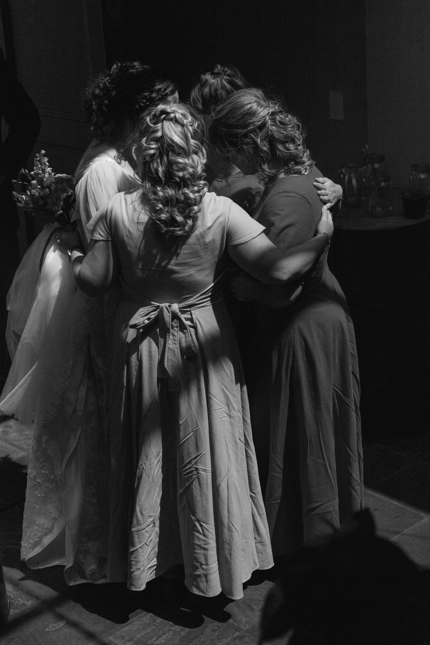 A sequence of black and white photos showing couples dancing and embracing in a dimly lit space.