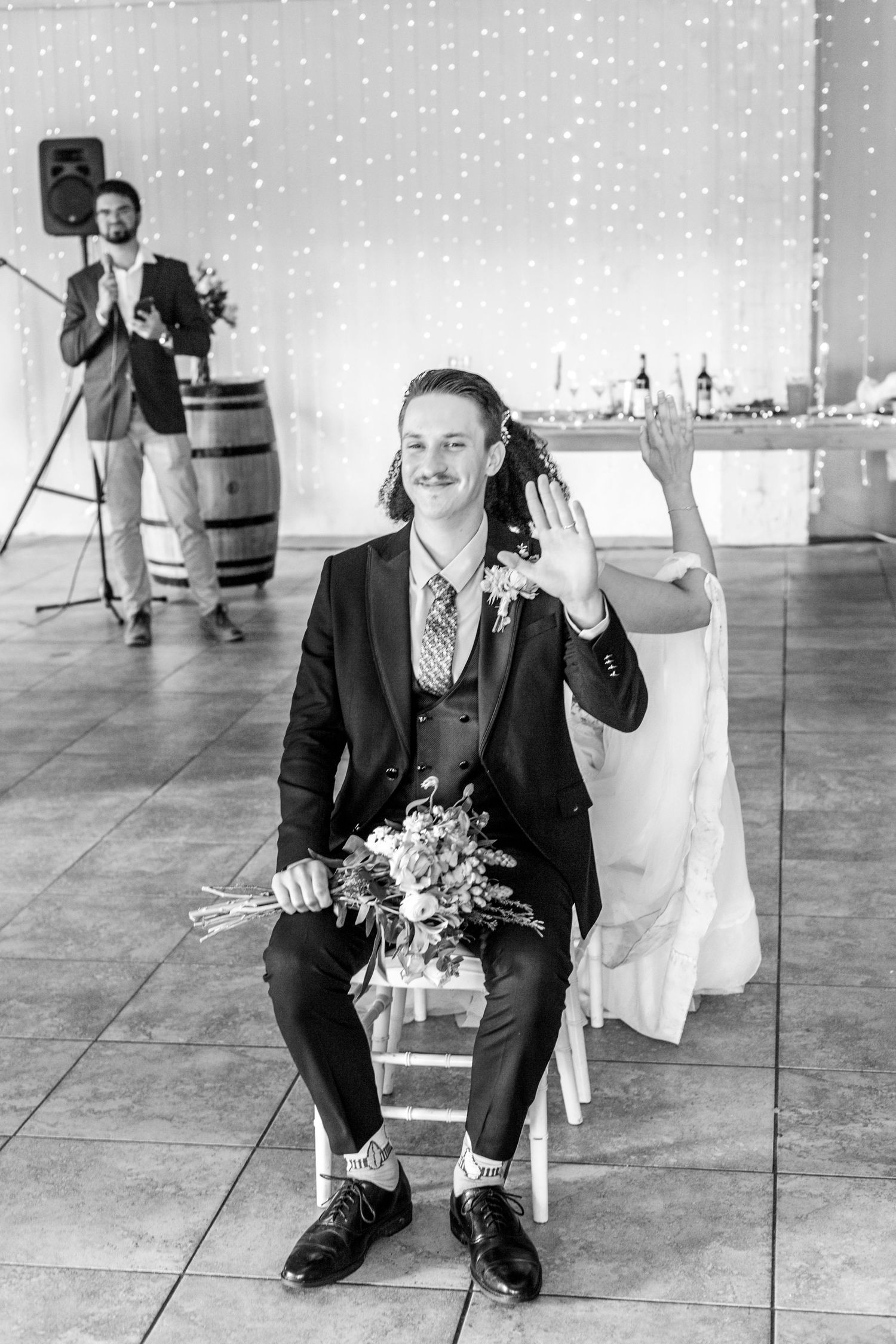 Three black and white images showing groomsmen kneeling and waving at a wedding reception venue.