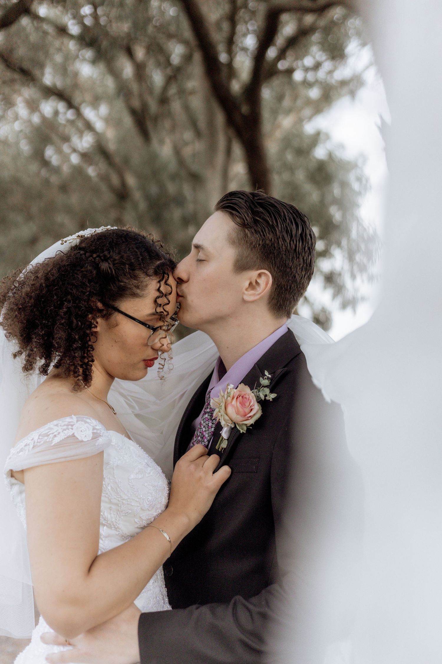 Romantic wedding kiss sequence showing multiple angles of newlyweds sharing their first kiss as a married couple.