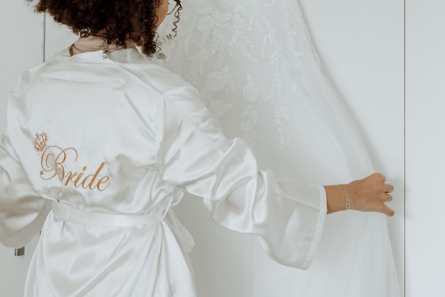 A collage showing a white bridal robe from multiple angles with delicate details and embroidered lettering.