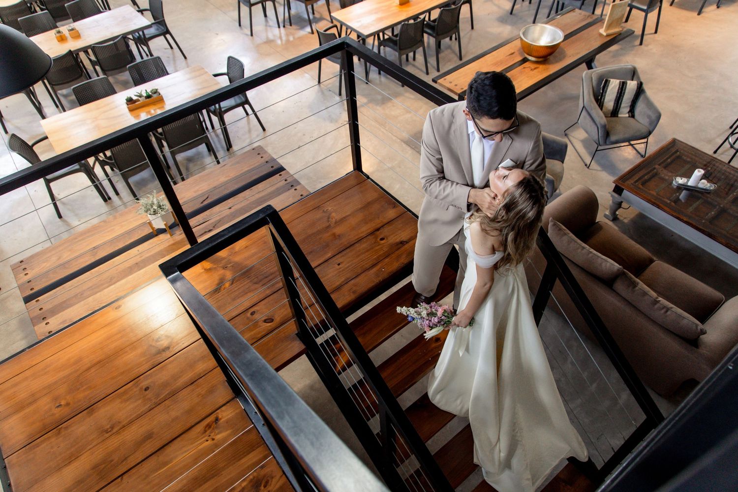 A sequence of photos showing a person in a white dress walking down wooden stairs in a restaurant setting.