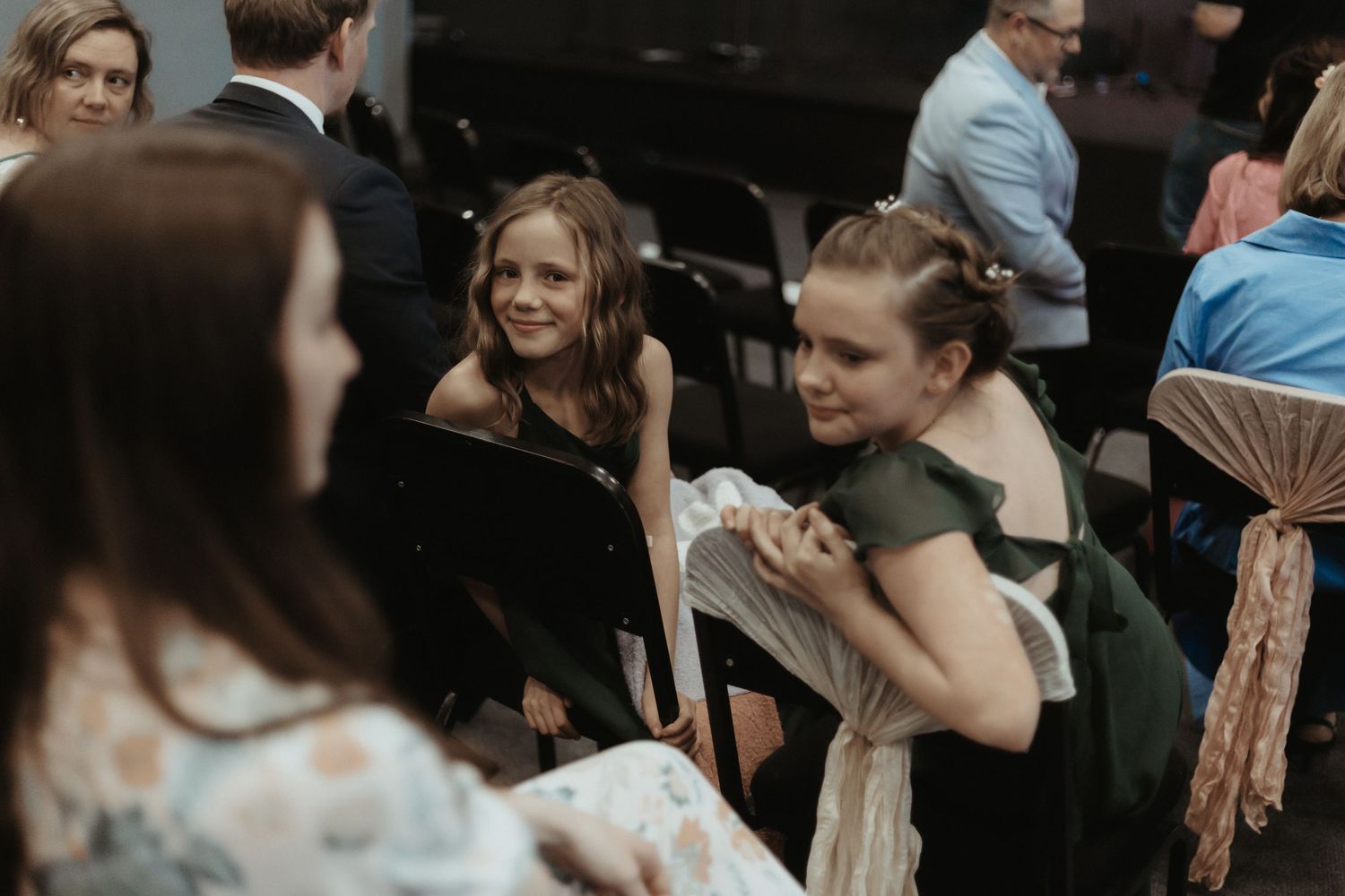 Wedding guests share emotional moments during a celebration at an indoor reception venue.