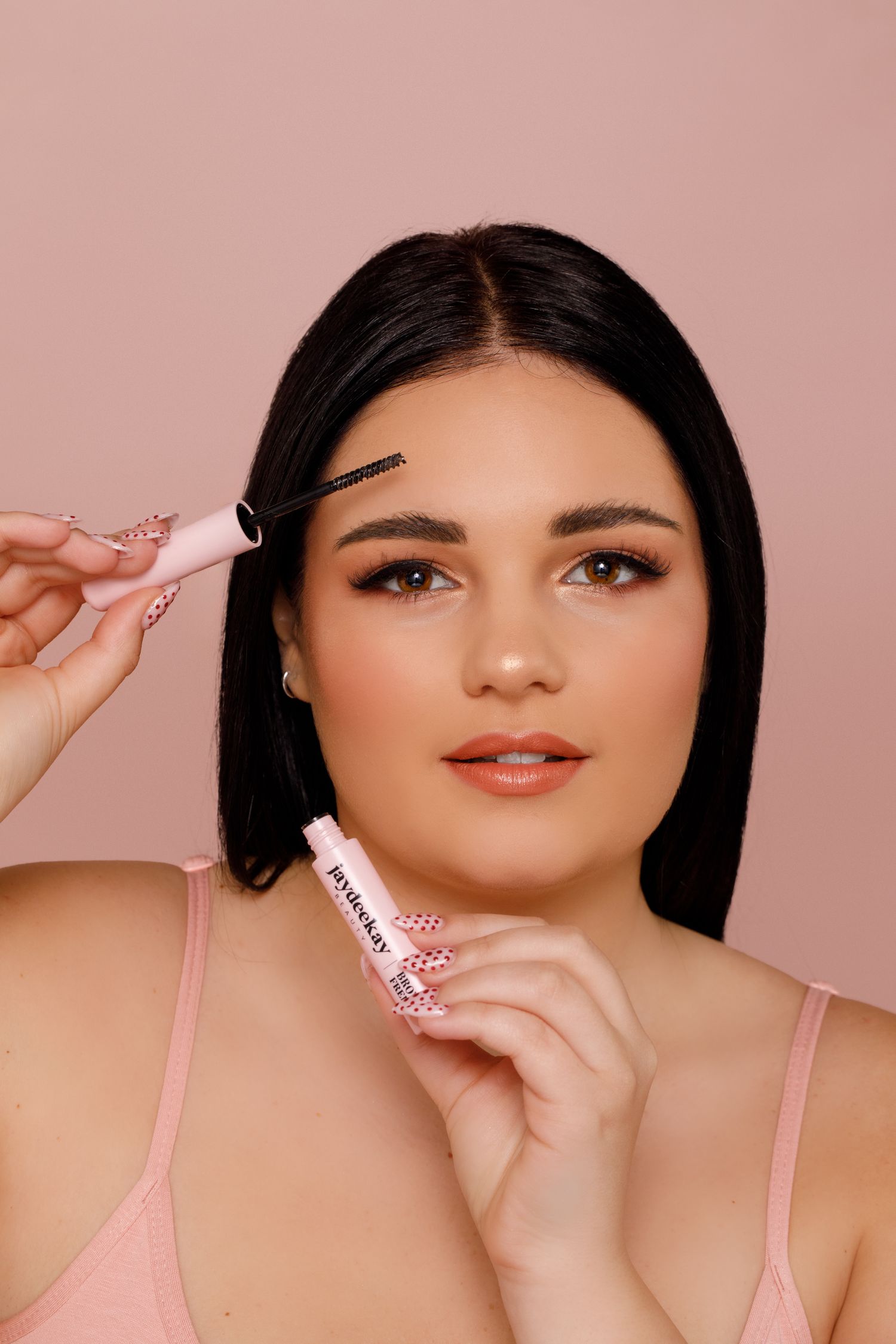 Beauty portrait series showing close-up shots of makeup and pink accessories against a soft pink background.
