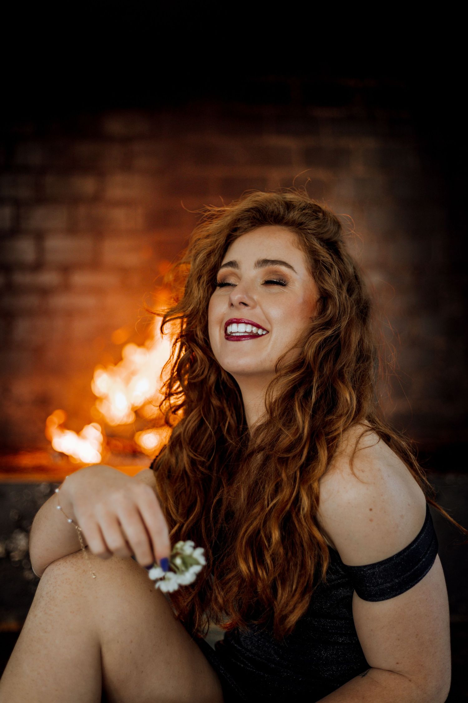 A sequence of five artistic portraits showing carefree expressions and dynamic movement against a warm fiery background.