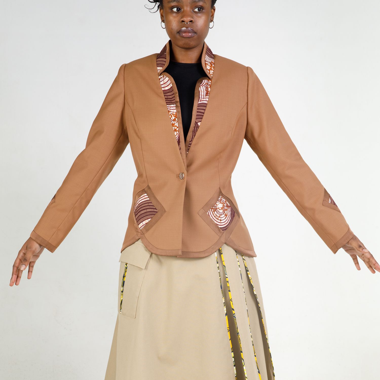 Cropped tan blazer styled with cream skirt, shown in multiple angles on light background showing fit and details.