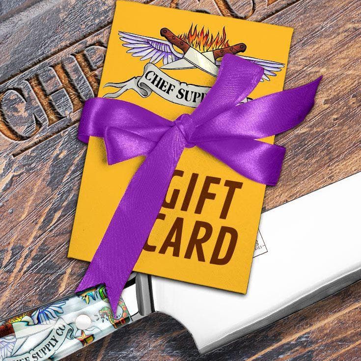 Yellow gift card with a purple bow from Chef Surf Shop displayed on a rustic wooden surface.