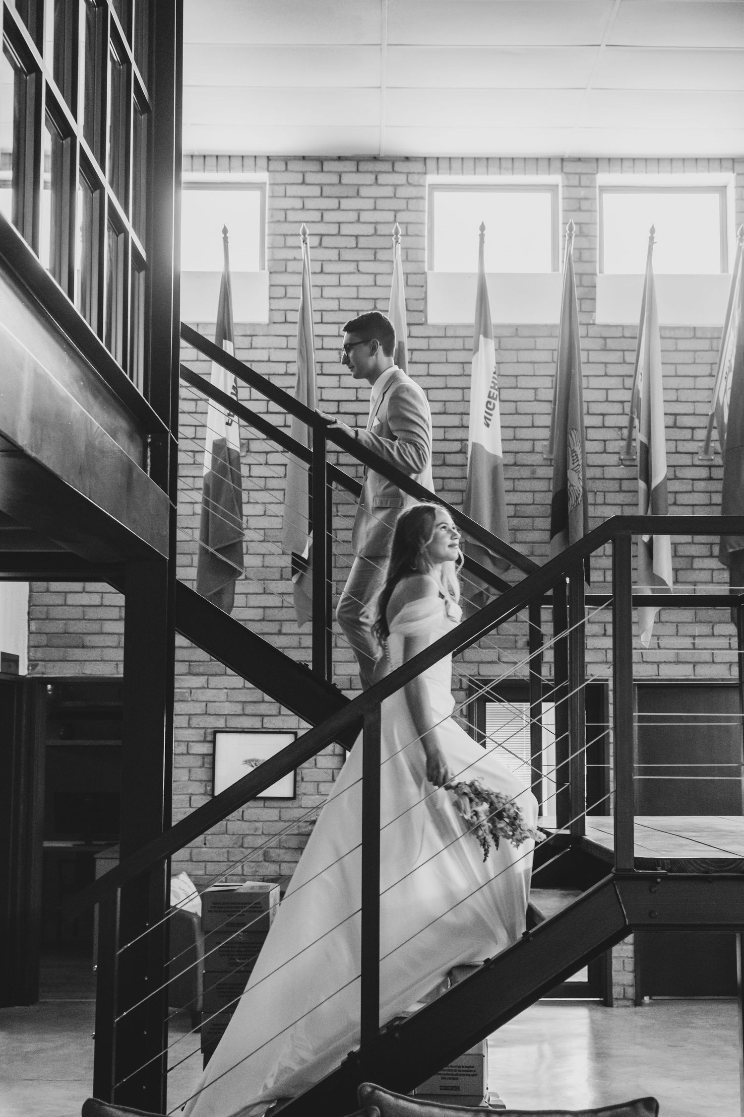 A sequence of black and white photos showing a couple ascending stairs, with the bride's dress flowing behind her.