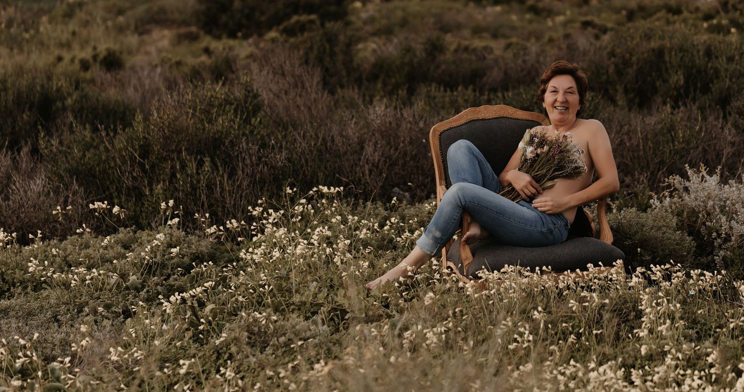 A series of photographs depicting a couple sitting in a wildflower meadow at sunset captures intimate moments in nature.