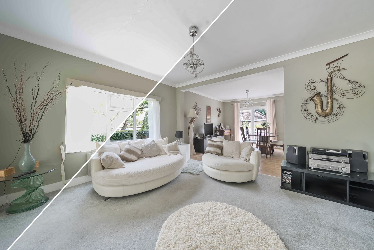 Modern living room with curved white sofas, green walls and contemporary decor.