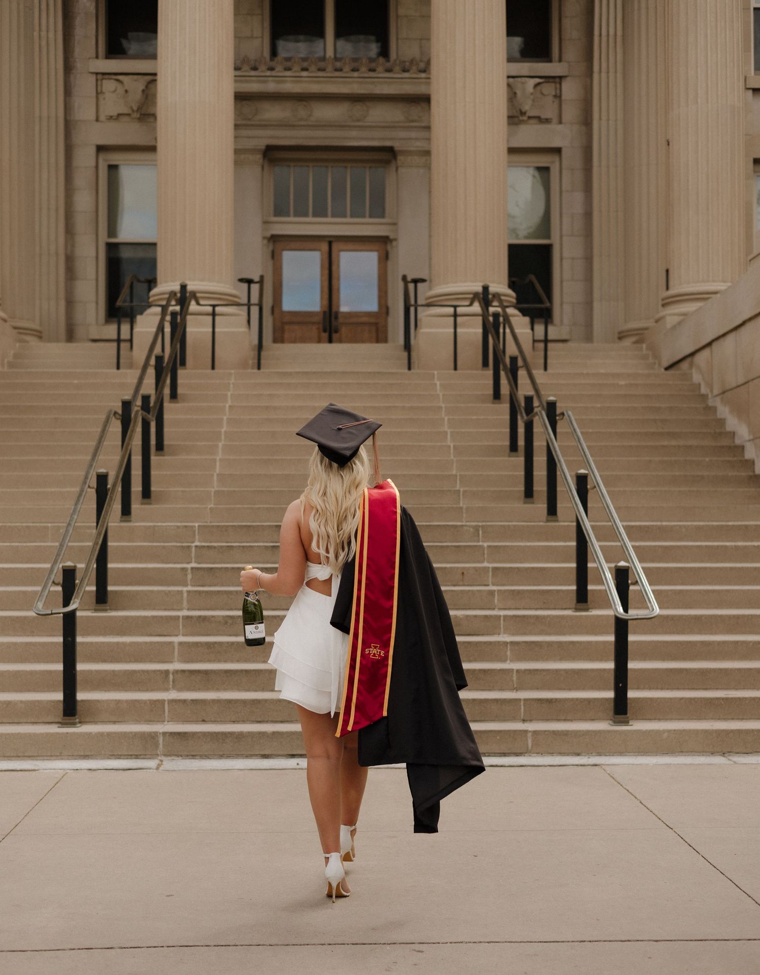 College senior walking away towards stairs at Iowa State University. #iowastateuniveristy #senior