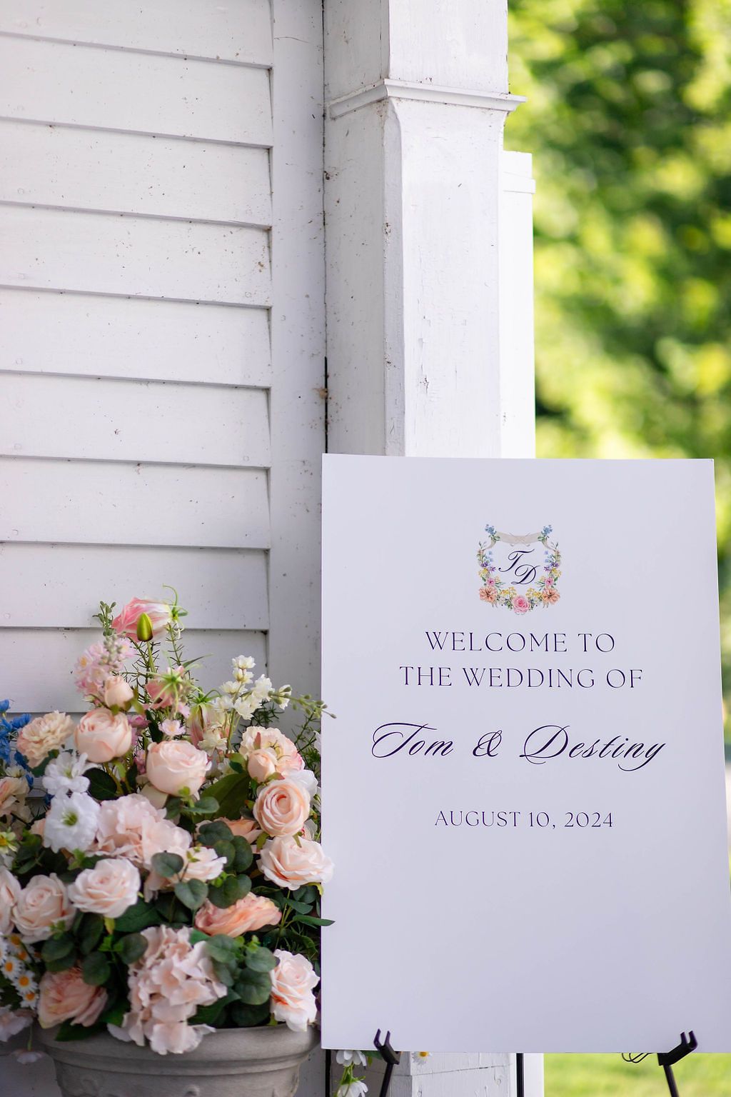 Elegant wedding welcome sign for Tom and Destiny, August 10 2024, displayed with blush pink floral arrangement.