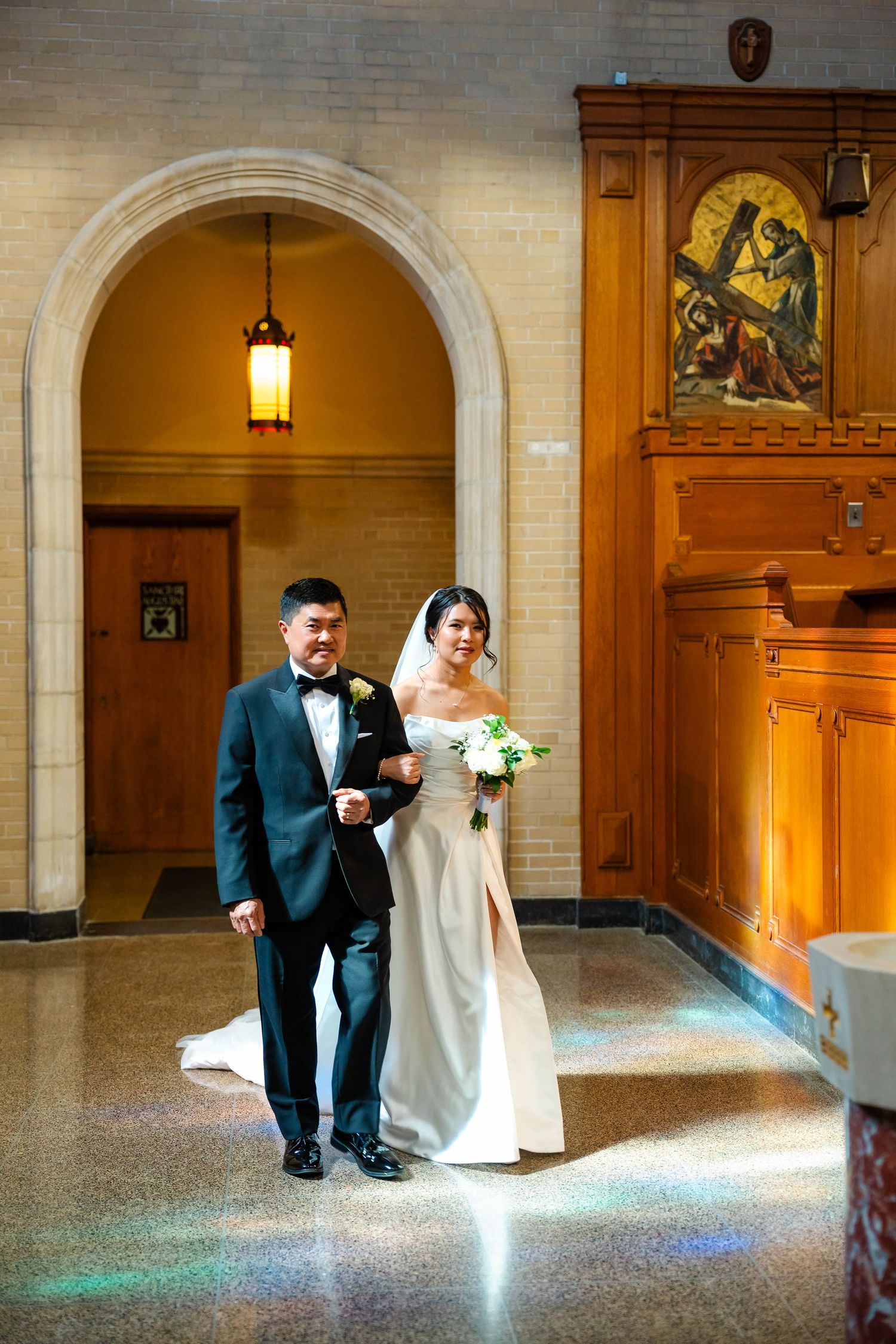 Bride and groom walking down the aisle of a church during wedding ceremony.