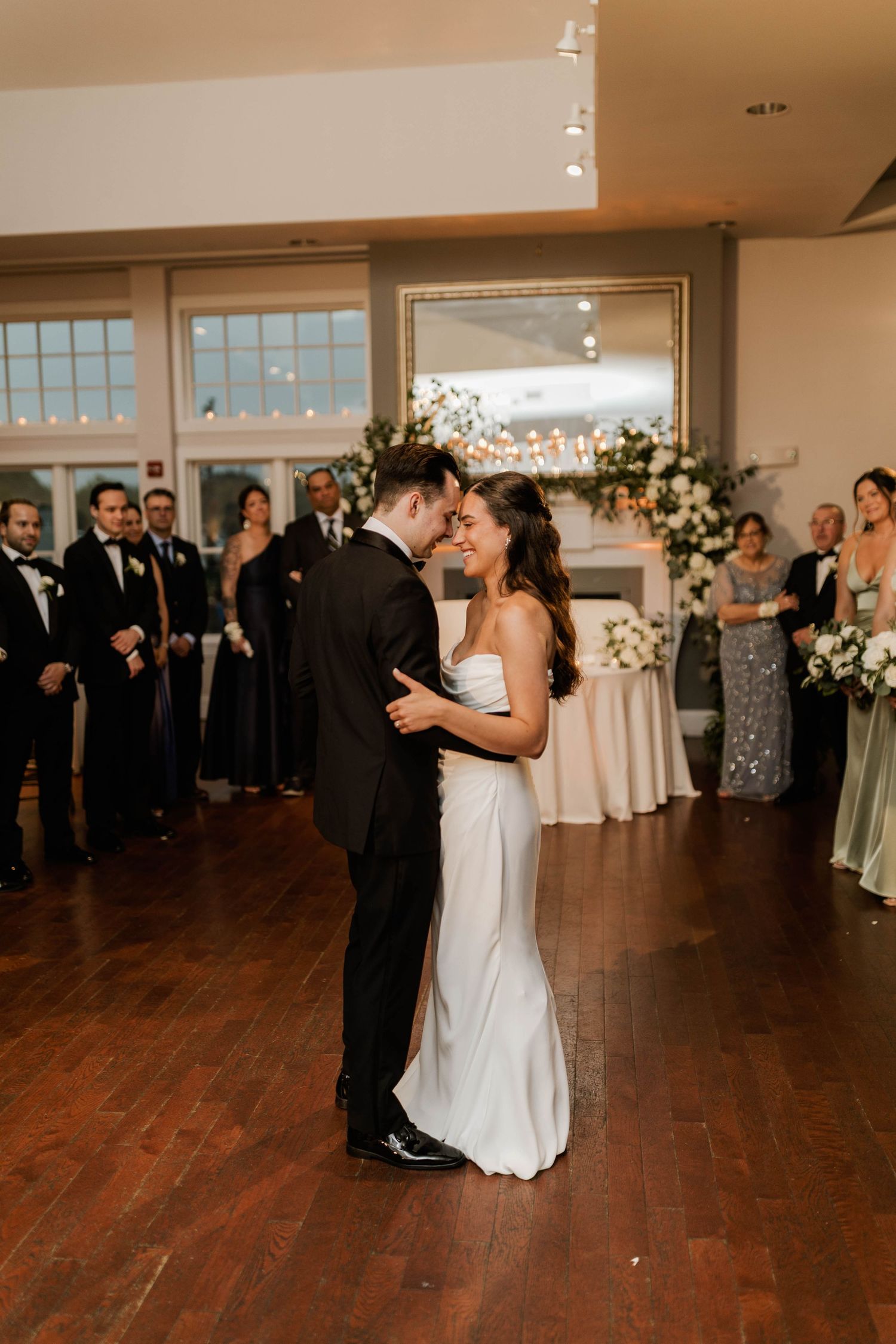 Bride and groom share first dance at elegant wedding reception.