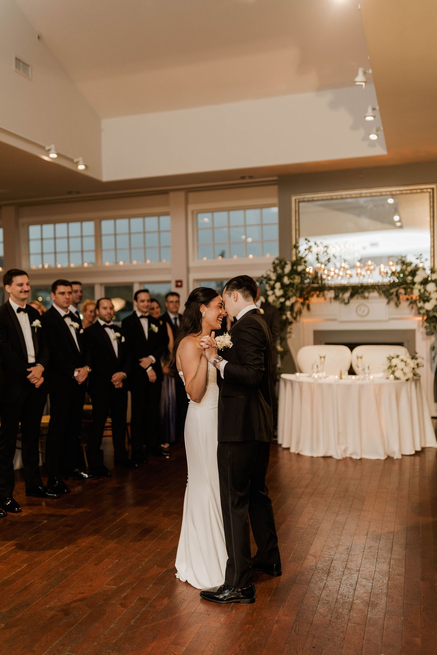 Bride and groom sharing first dance at elegant wedding reception.