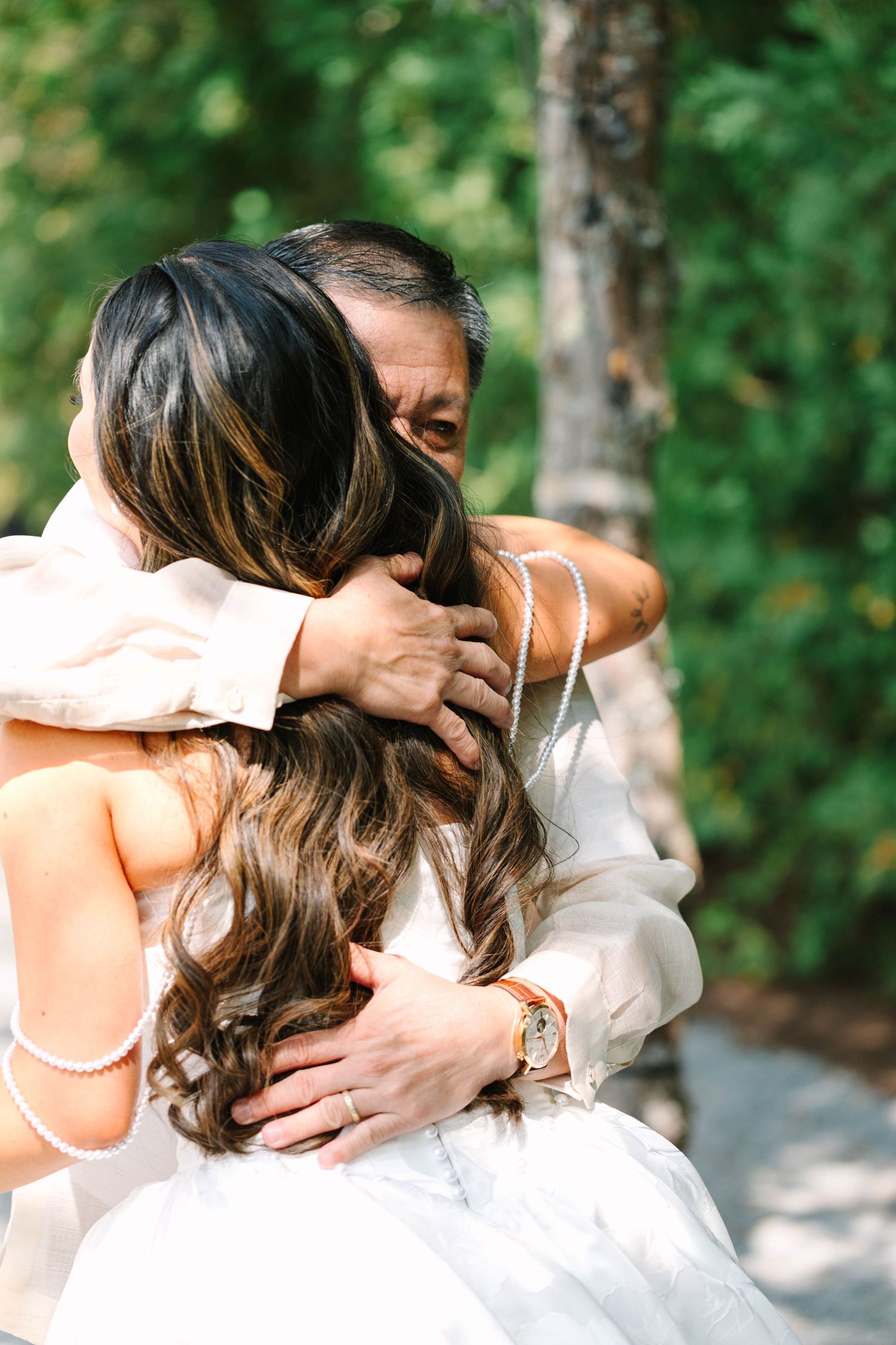 Father of the bride embraces his daughter in an emotional hug during their first look before the ceremony.