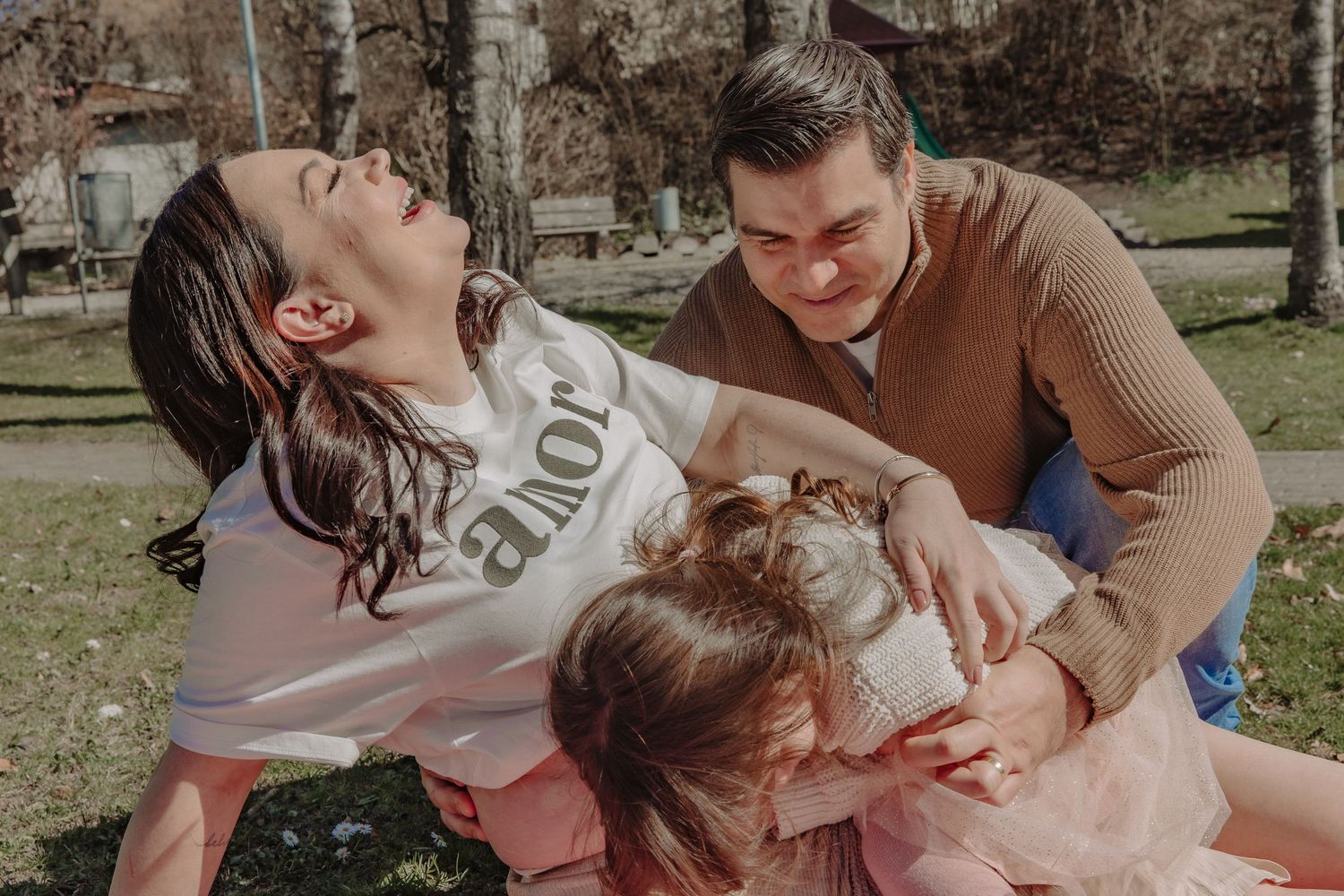 A candid moment of laughter captured during a family picnic on a sunny spring day.