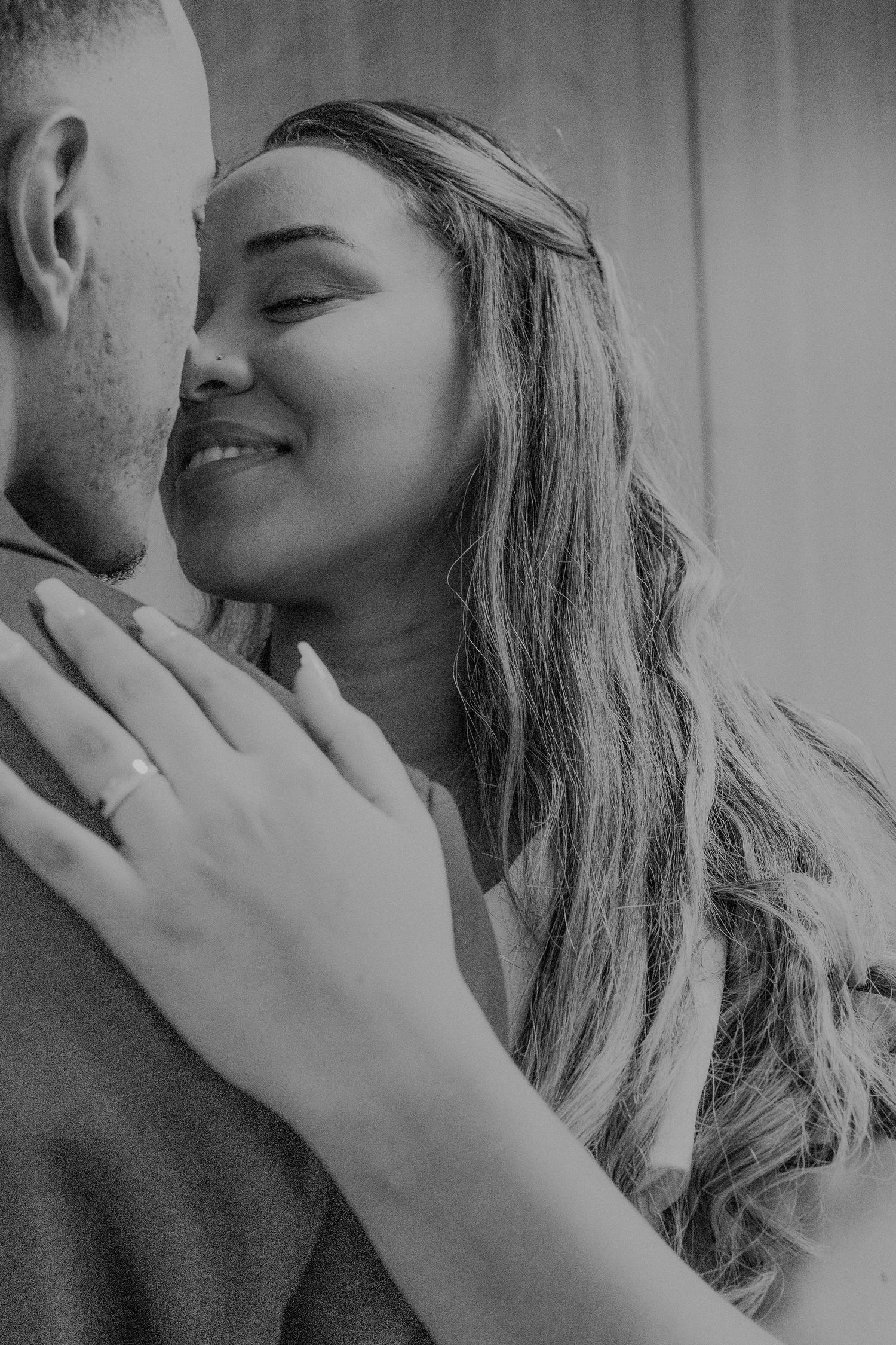 Black and white intimate wedding portrait showing tender moment.