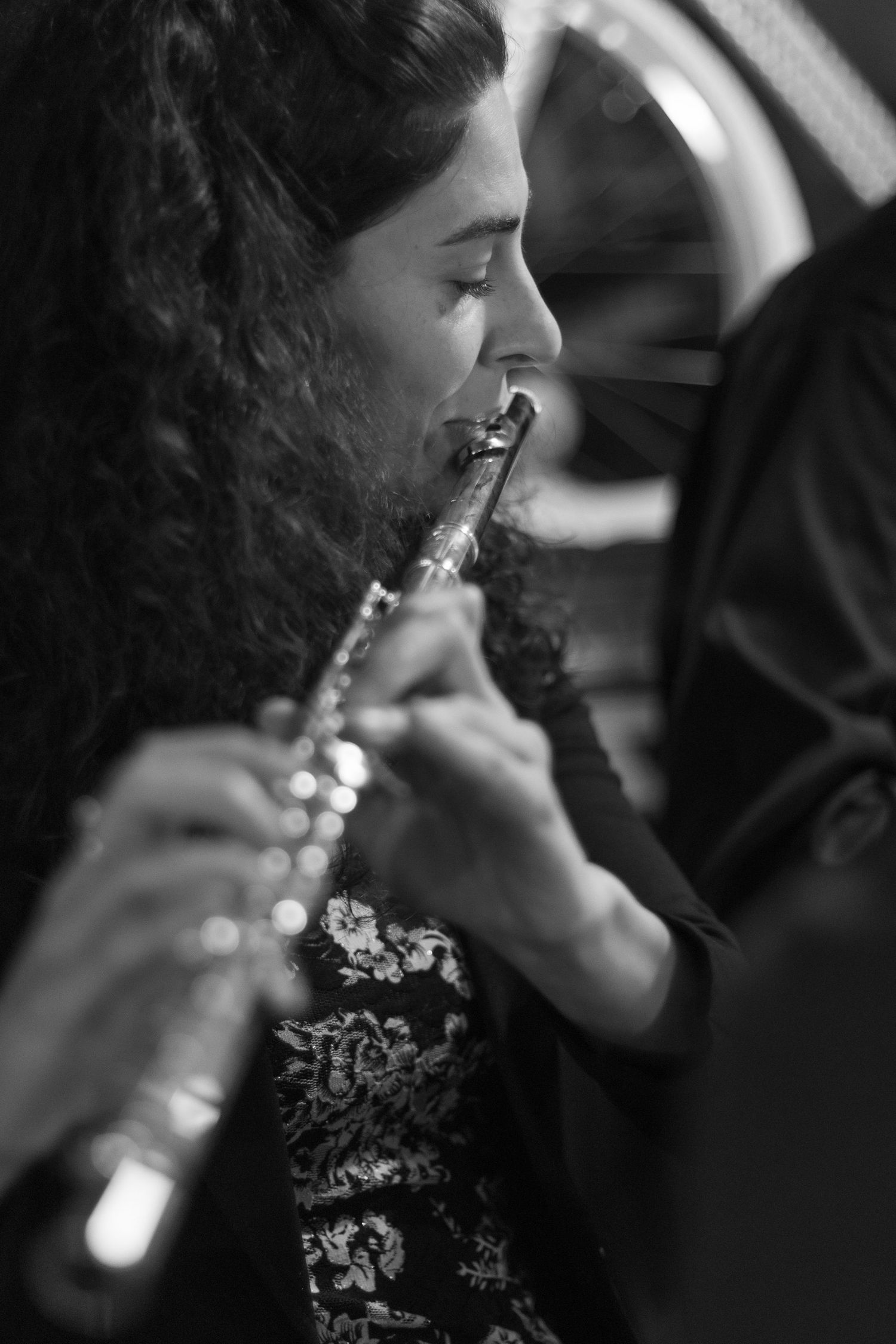 Black and white photo of flautist performing with focused expression.