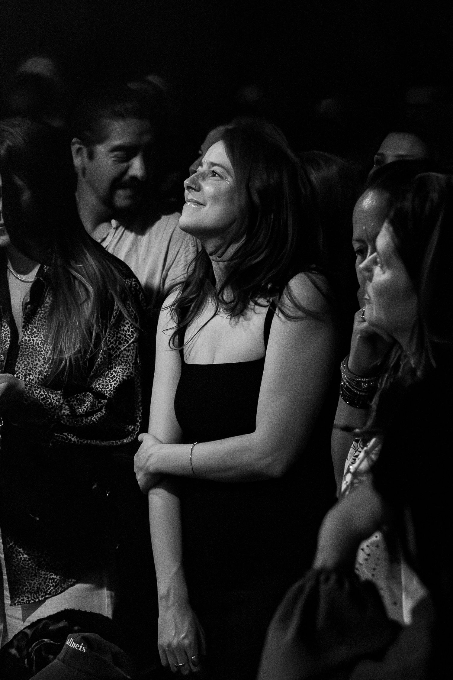Audience members smile and enjoy themselves at a live entertainment event.