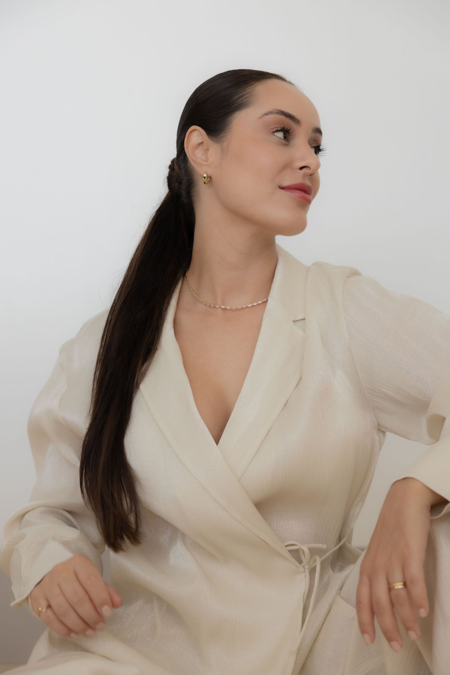 Woman in elegant cream suit posing against white background. female portrait , female portrait photographer in Zürich