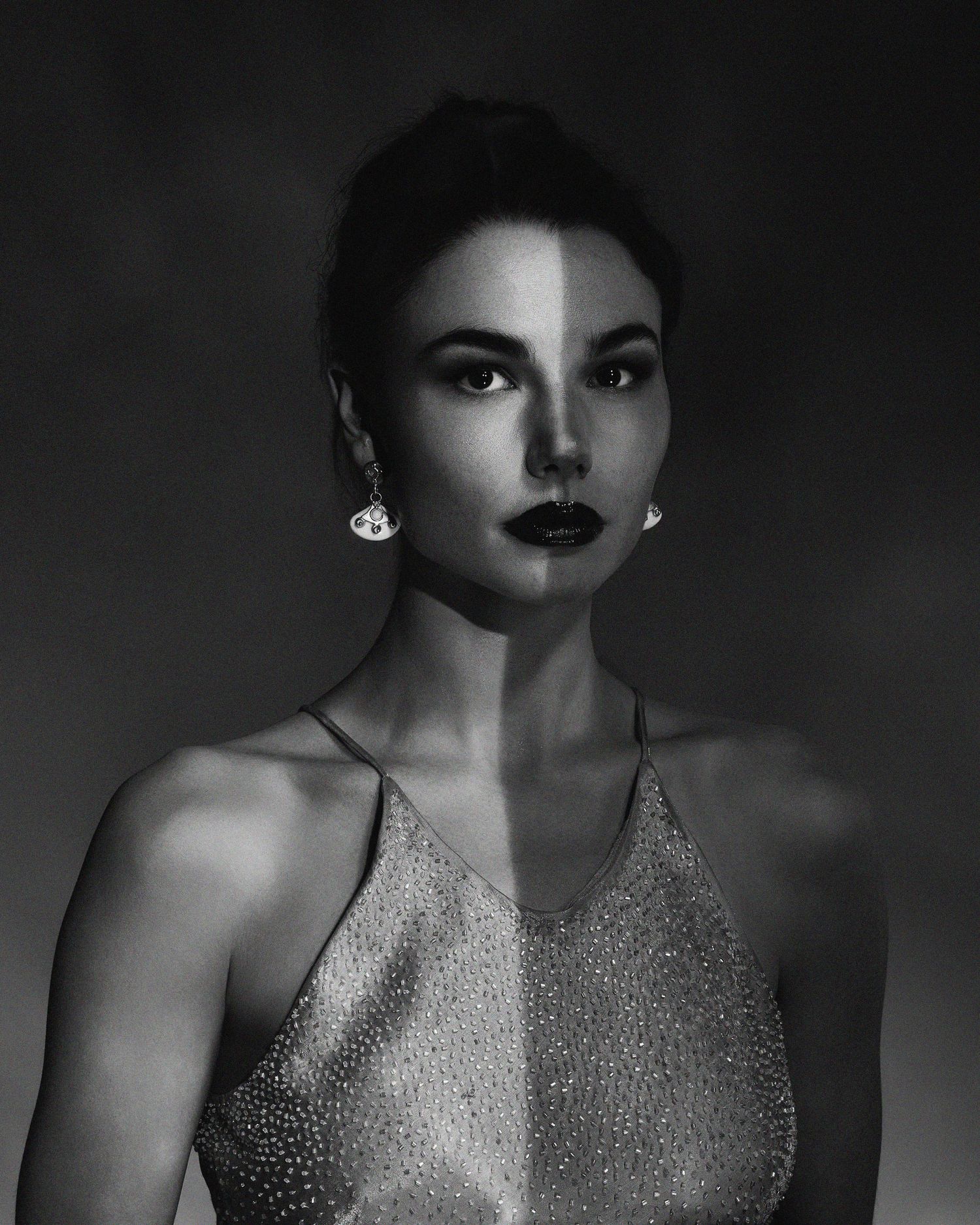 Artistic black and white close-up portraits showcasing sparkly evening wear and dramatic lighting.