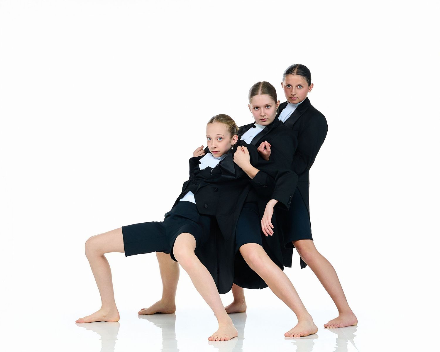 Contemporary dancers in black attire performing sequential movement poses.