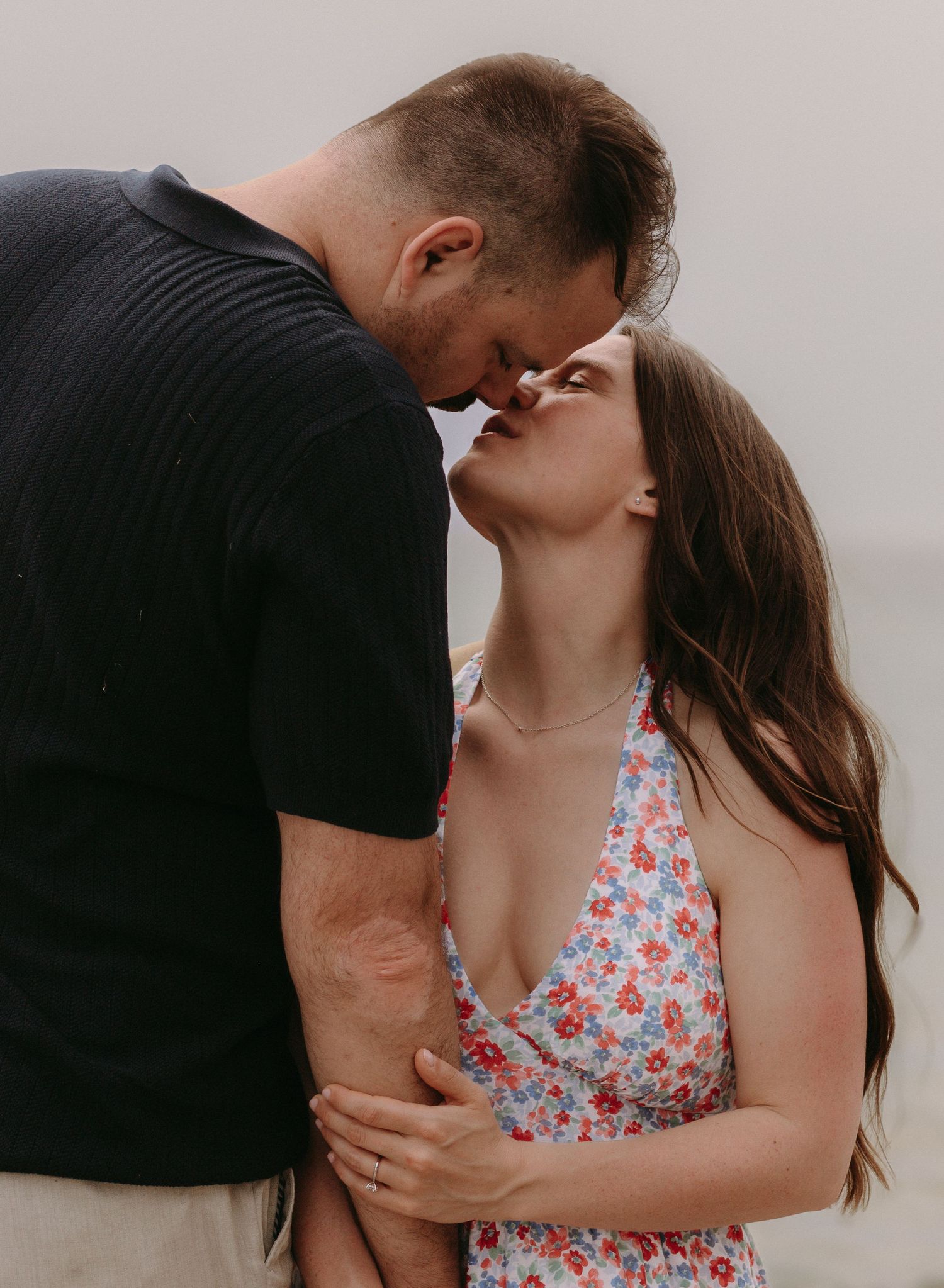 Intimate romantic moment captured between couple against natural background.