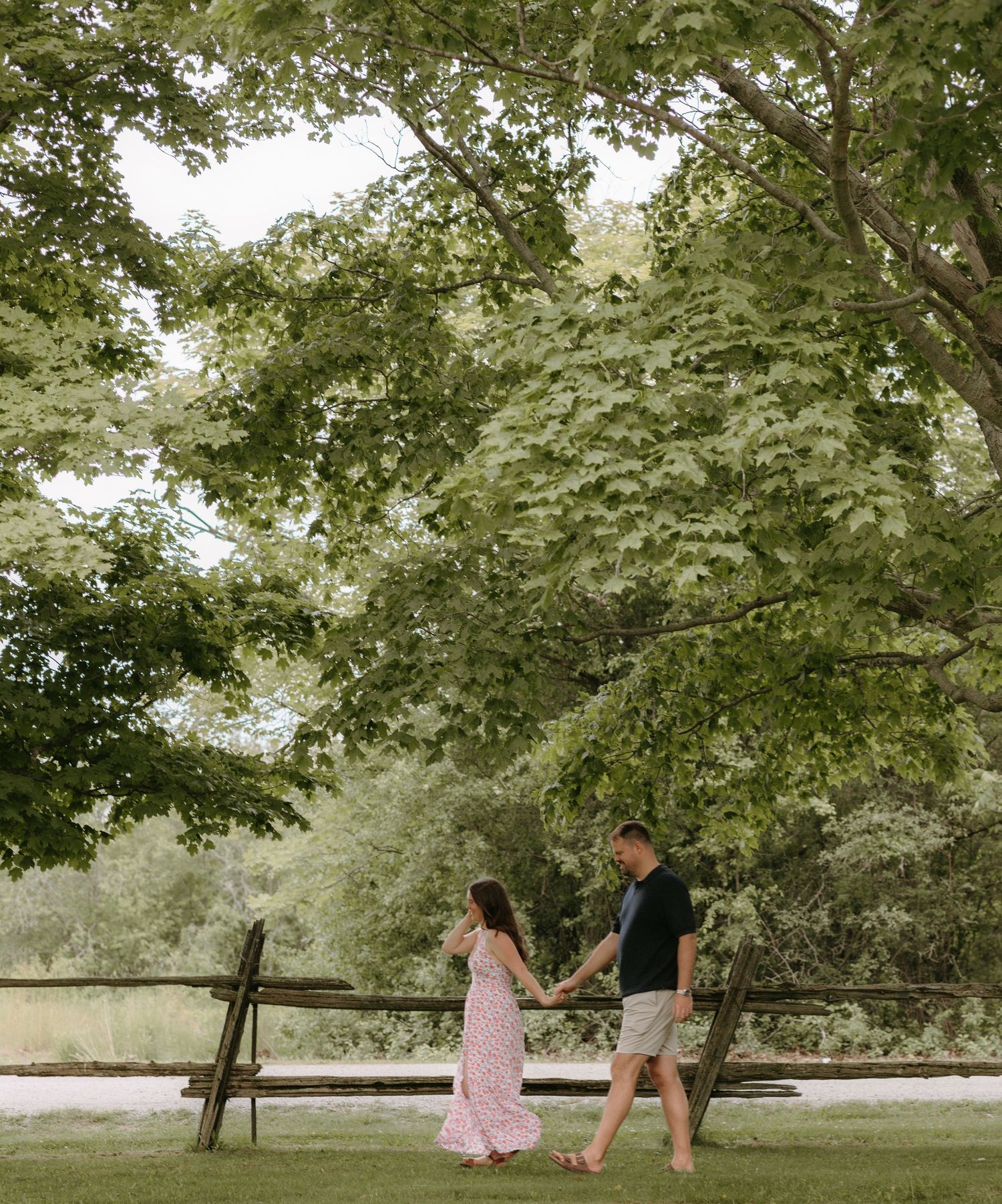 A romantic photoshoot sequence in a lush green park setting.