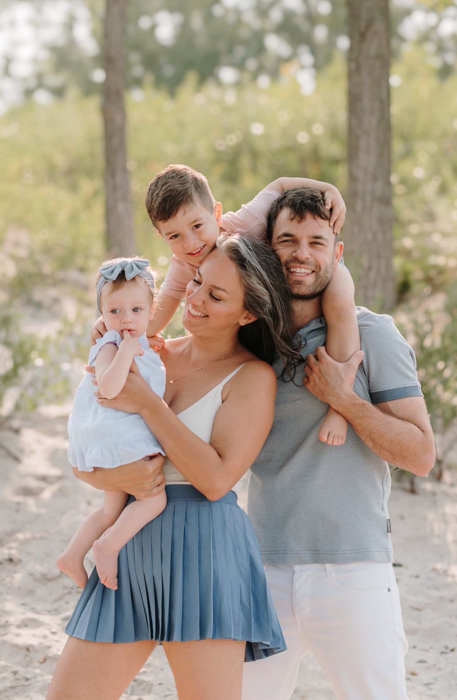 Candid family photos capturing playful interactions in natural beach setting.