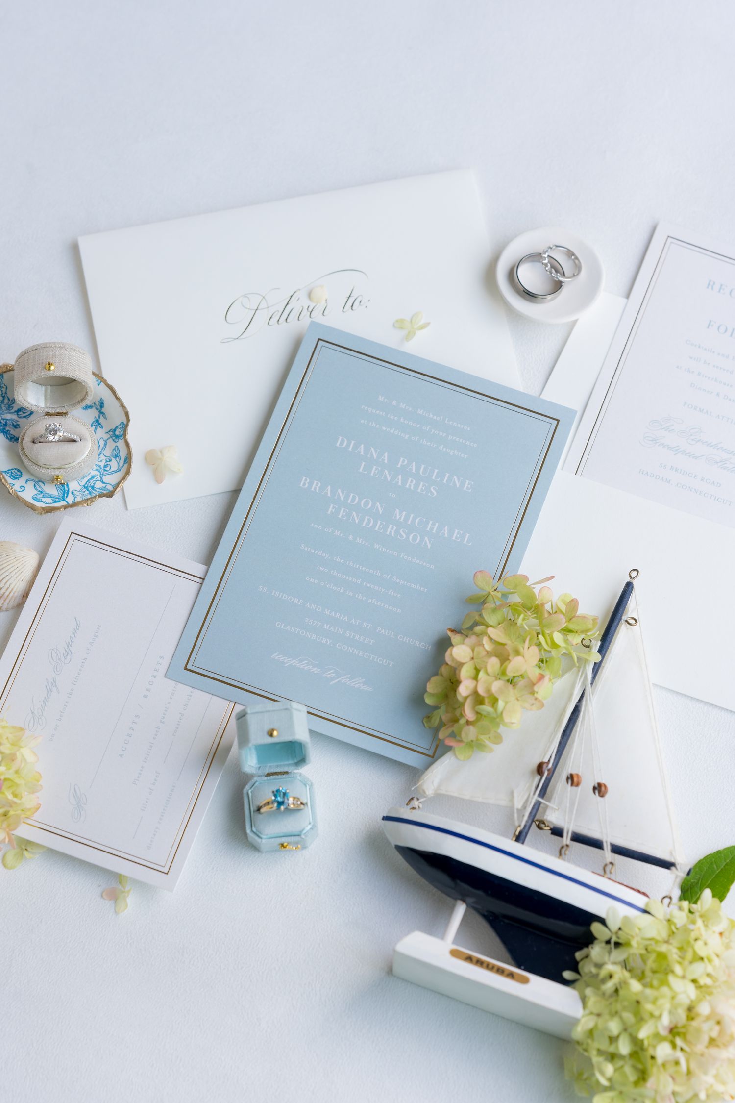 Wedding invitation suite in light blue with nautical theme and floral accents.