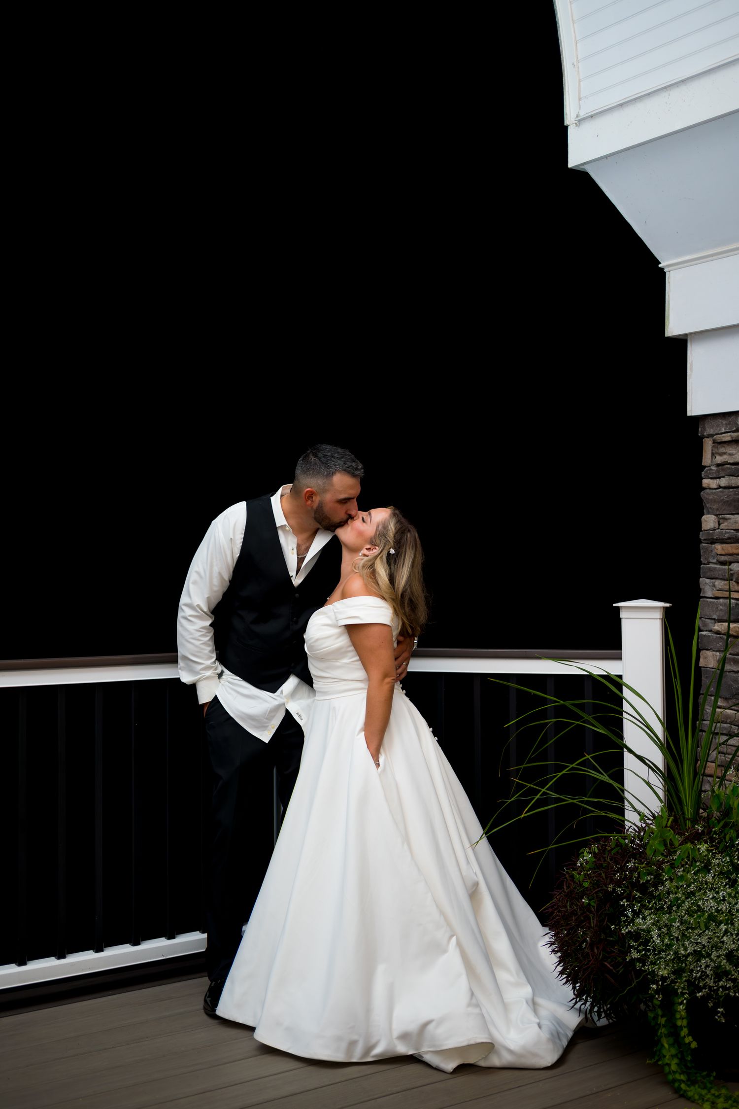 Romantic black and white silhouette of a couple embracing on their wedding day.
