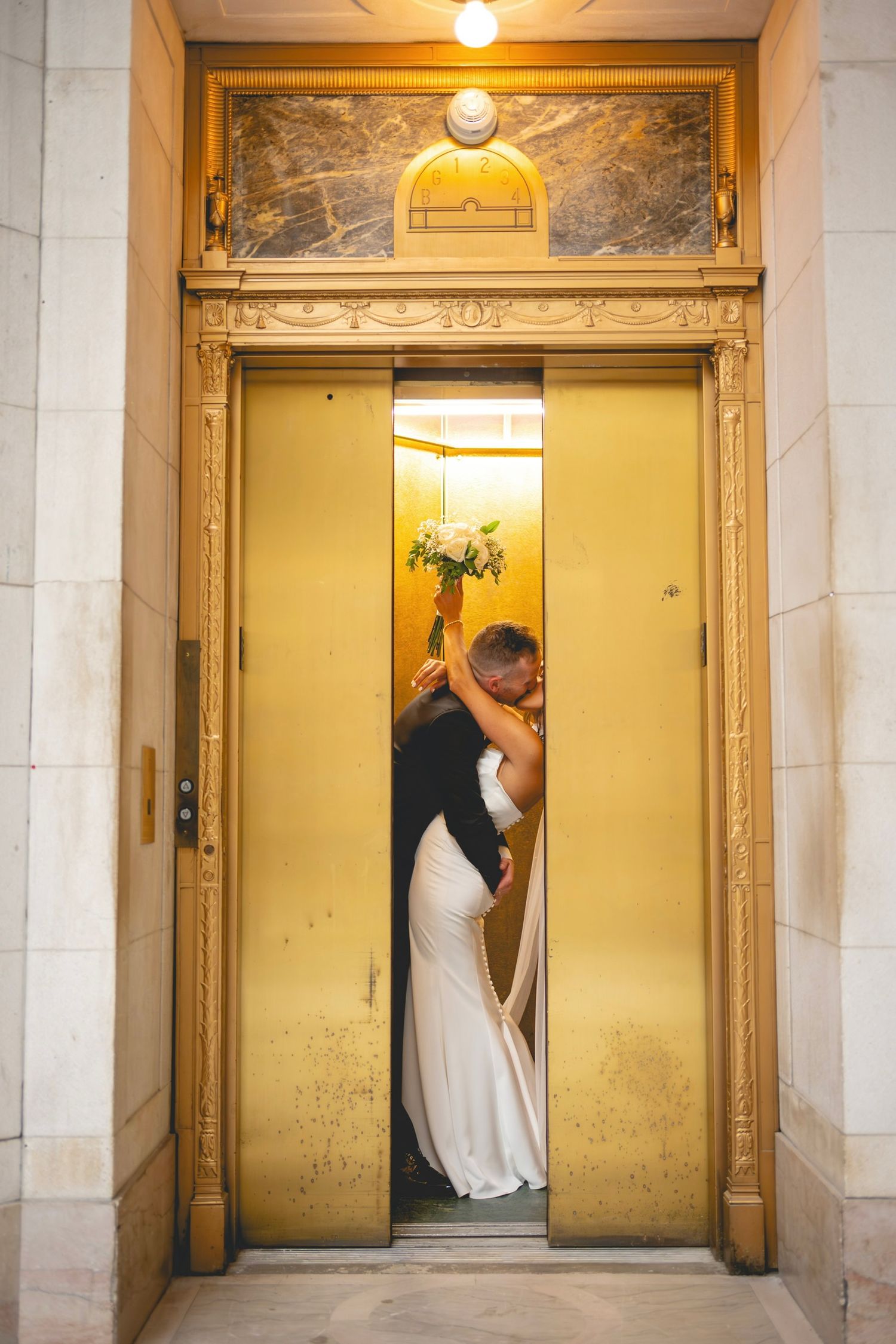 Series of romantic elevator shots showing couple in wedding attire at Hartford City Hall in Connecticut.