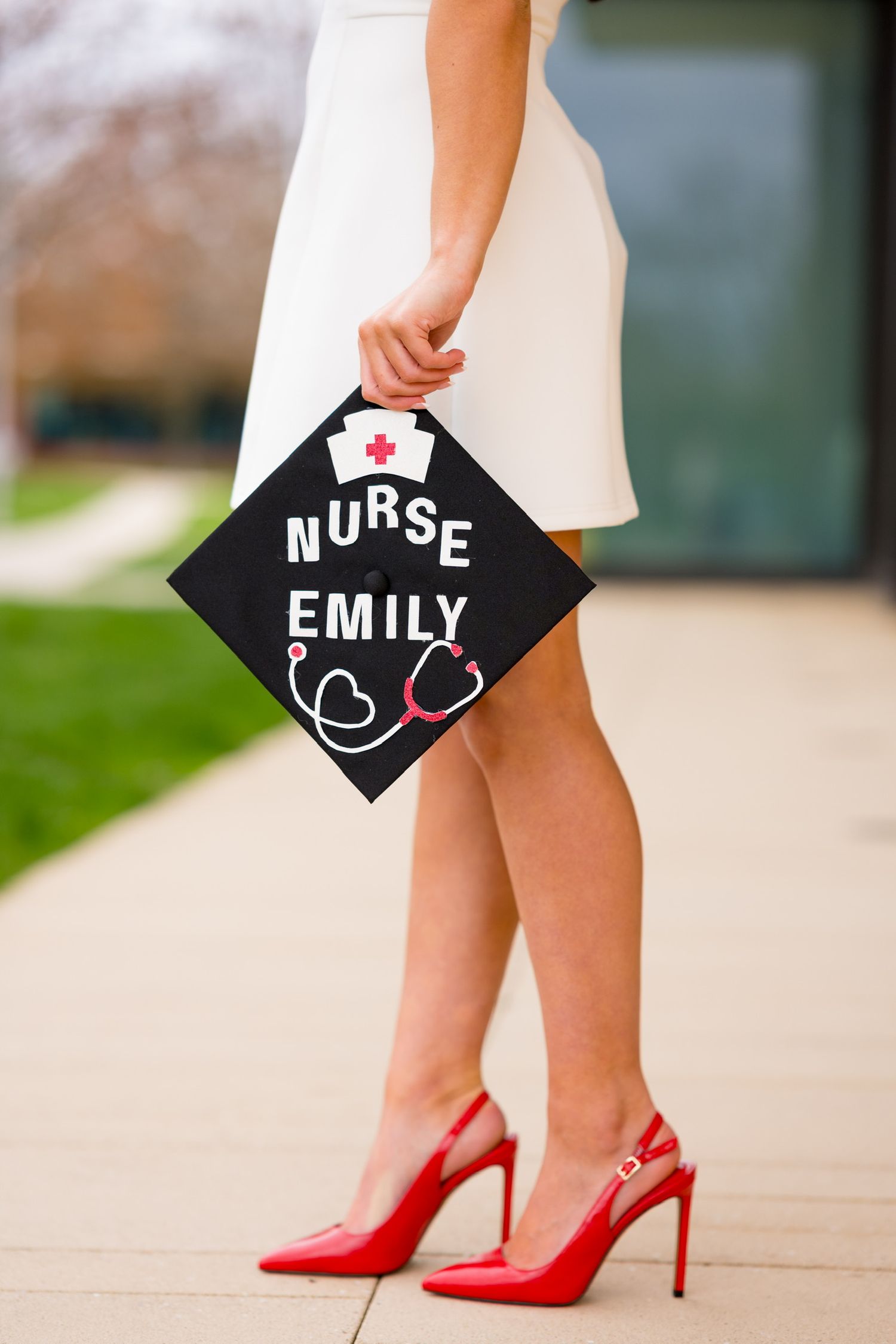 Red high heels and graduation cap decorations showing nursing school accomplishment at Sacred Heart University.