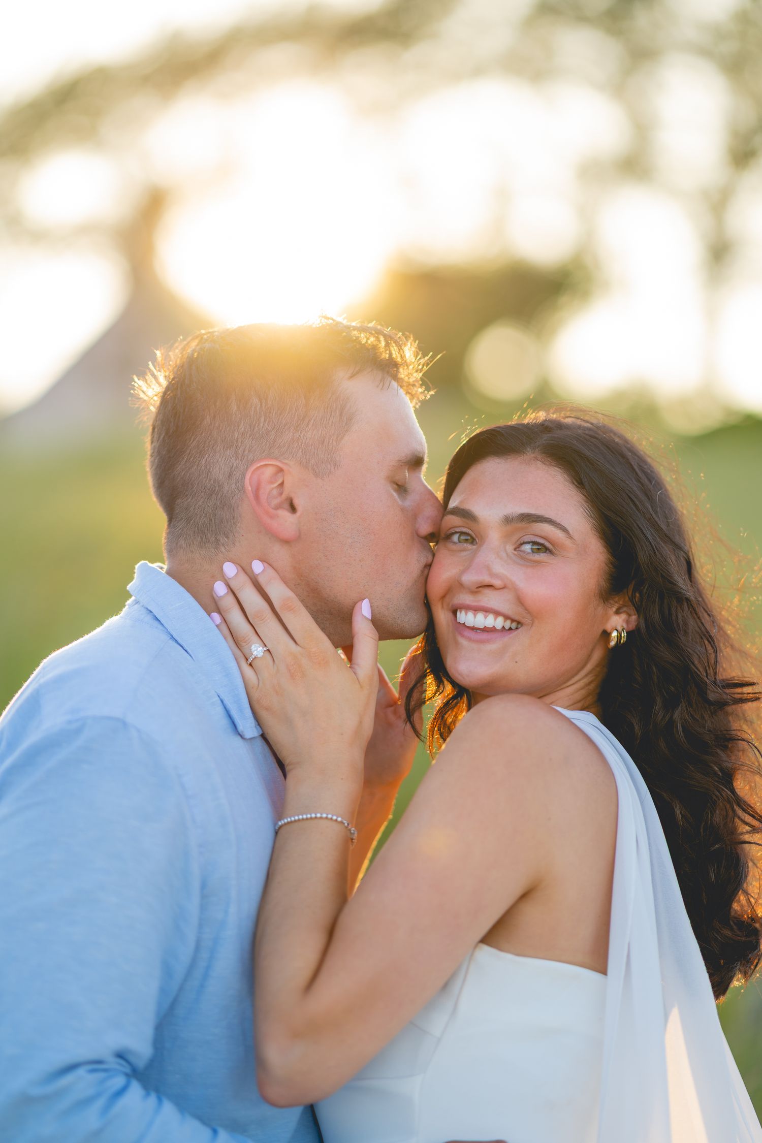 Close-up of couple's loving embrace during sunset beach photoshoot in Cape Cod.