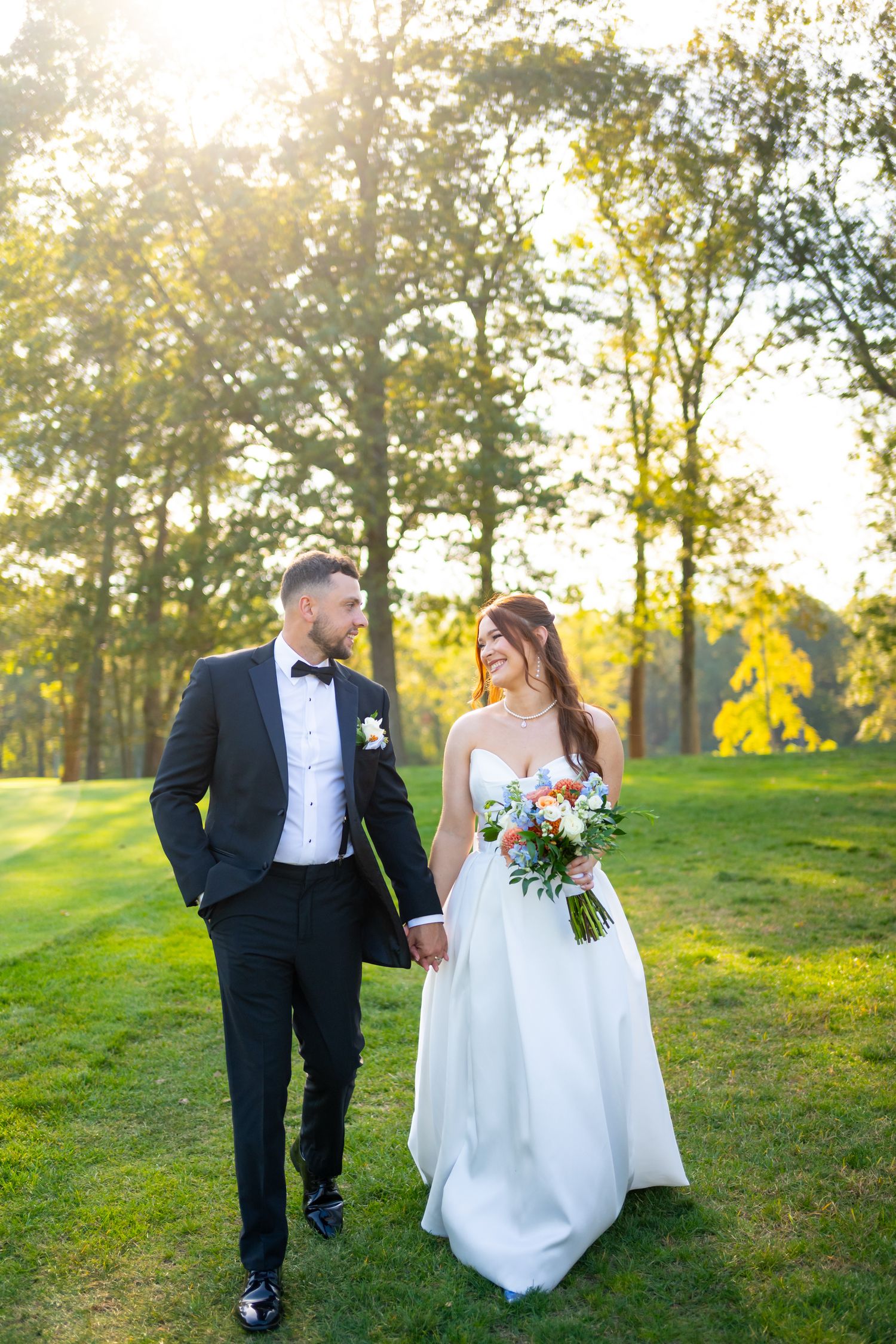 A romantic wedding sequence shows a couple walking through a sunlit field at golden hour.