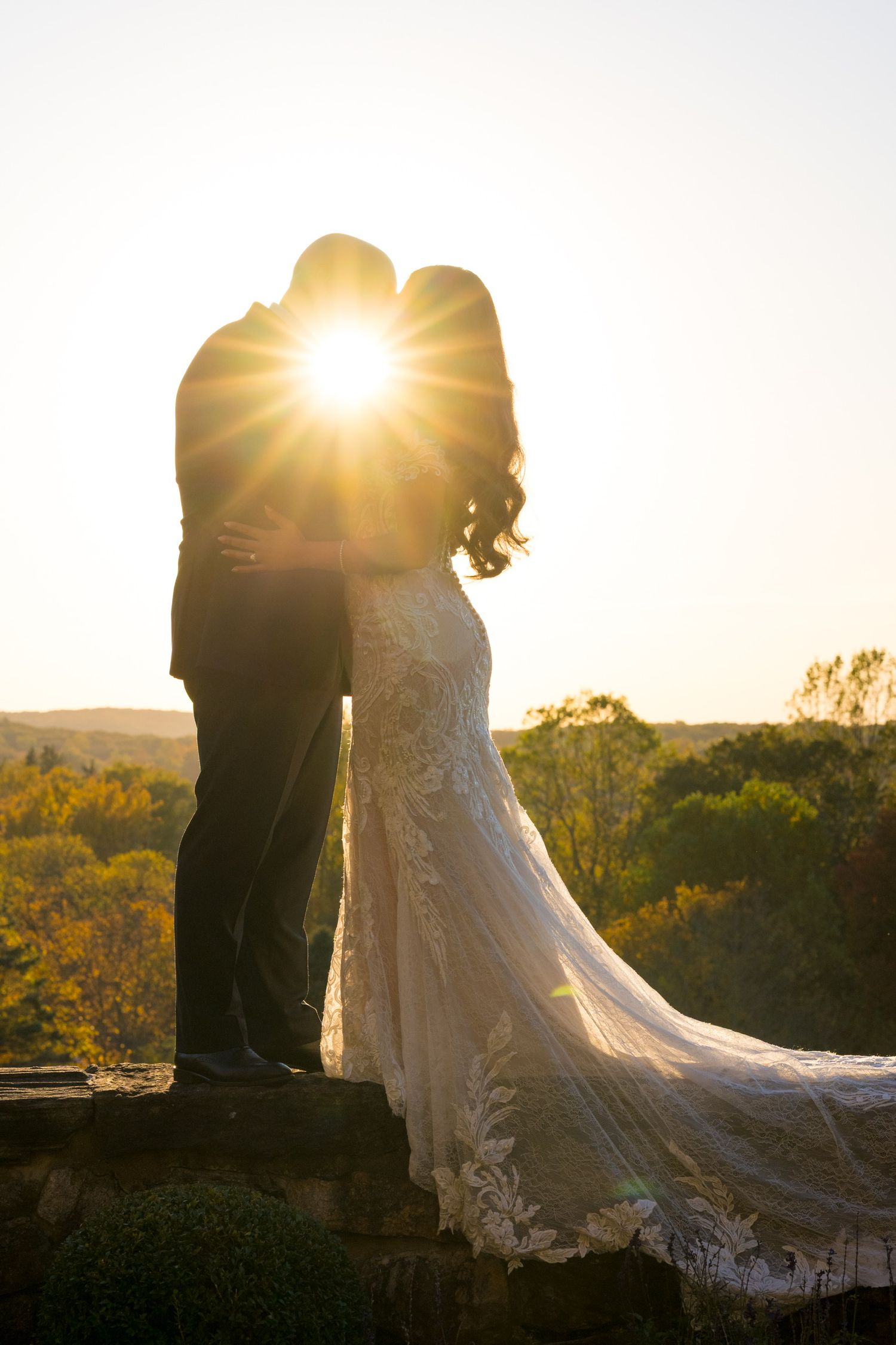 A silhouetted wedding couple embraces during sunset at Le Chateau in Westchester County, New York.