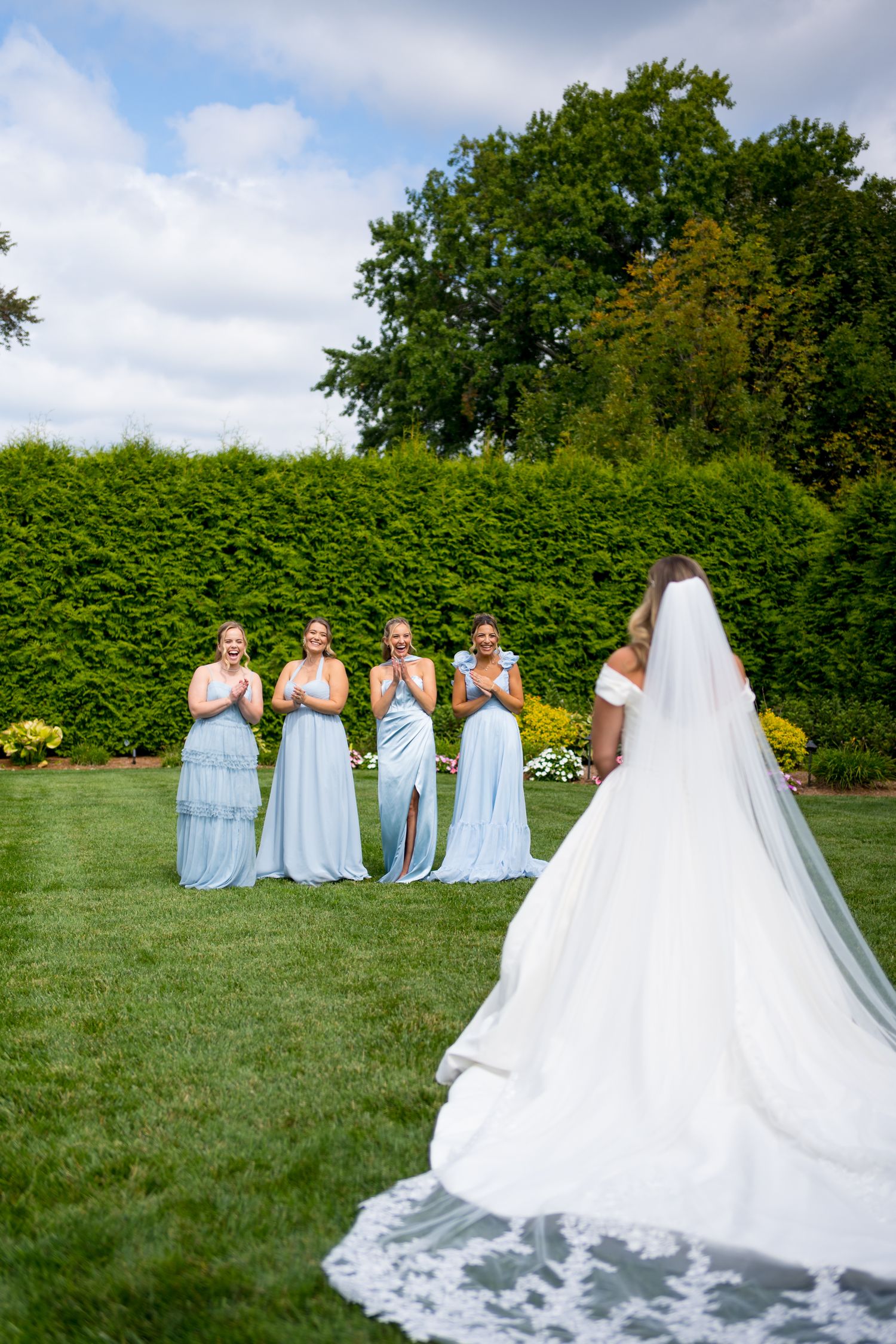 A wedding scene shows bridesmaids in light blue dresses reacting to the bride's dramatic cathedral veil.