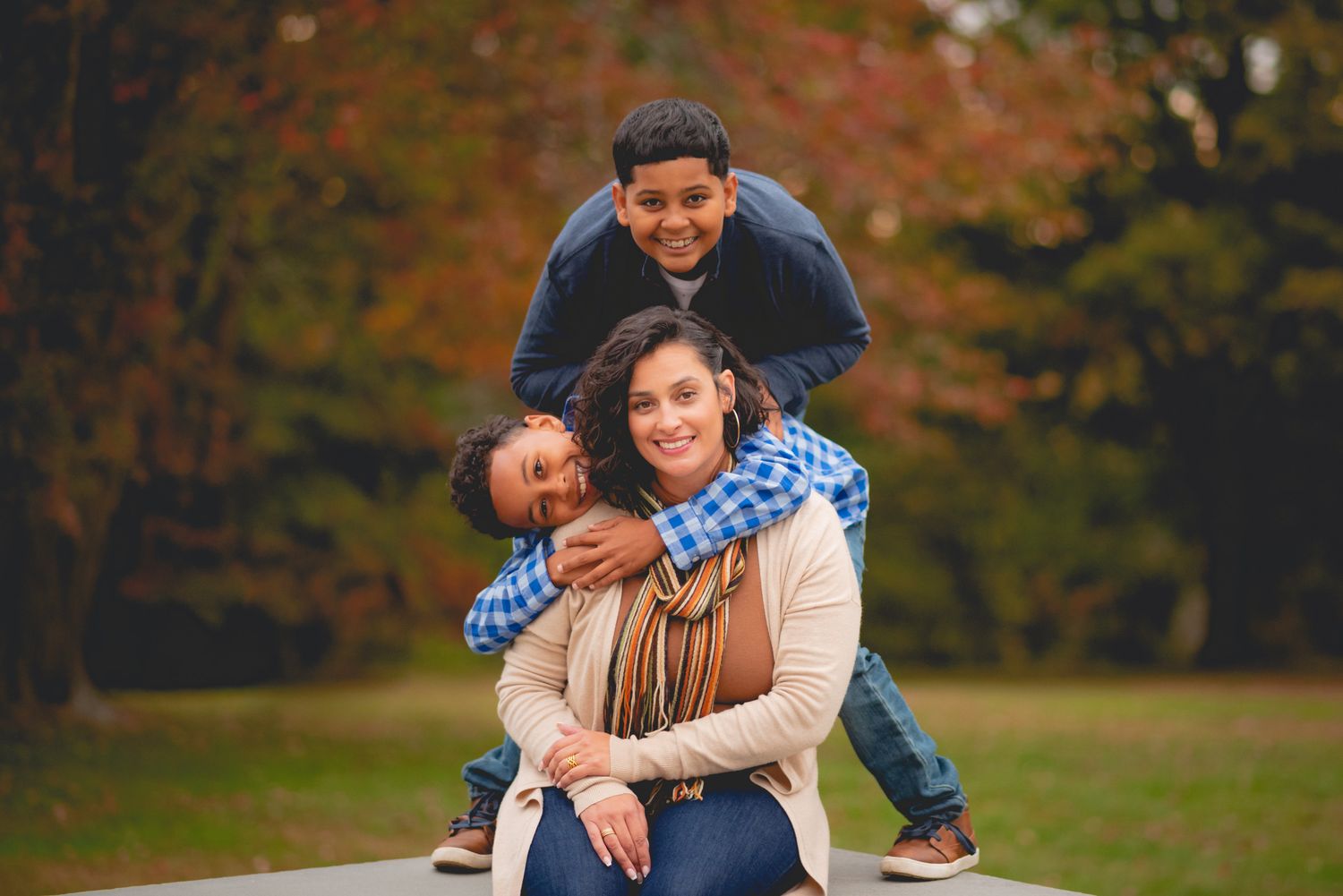 Playful moments captured in autumn park with fall foliage.