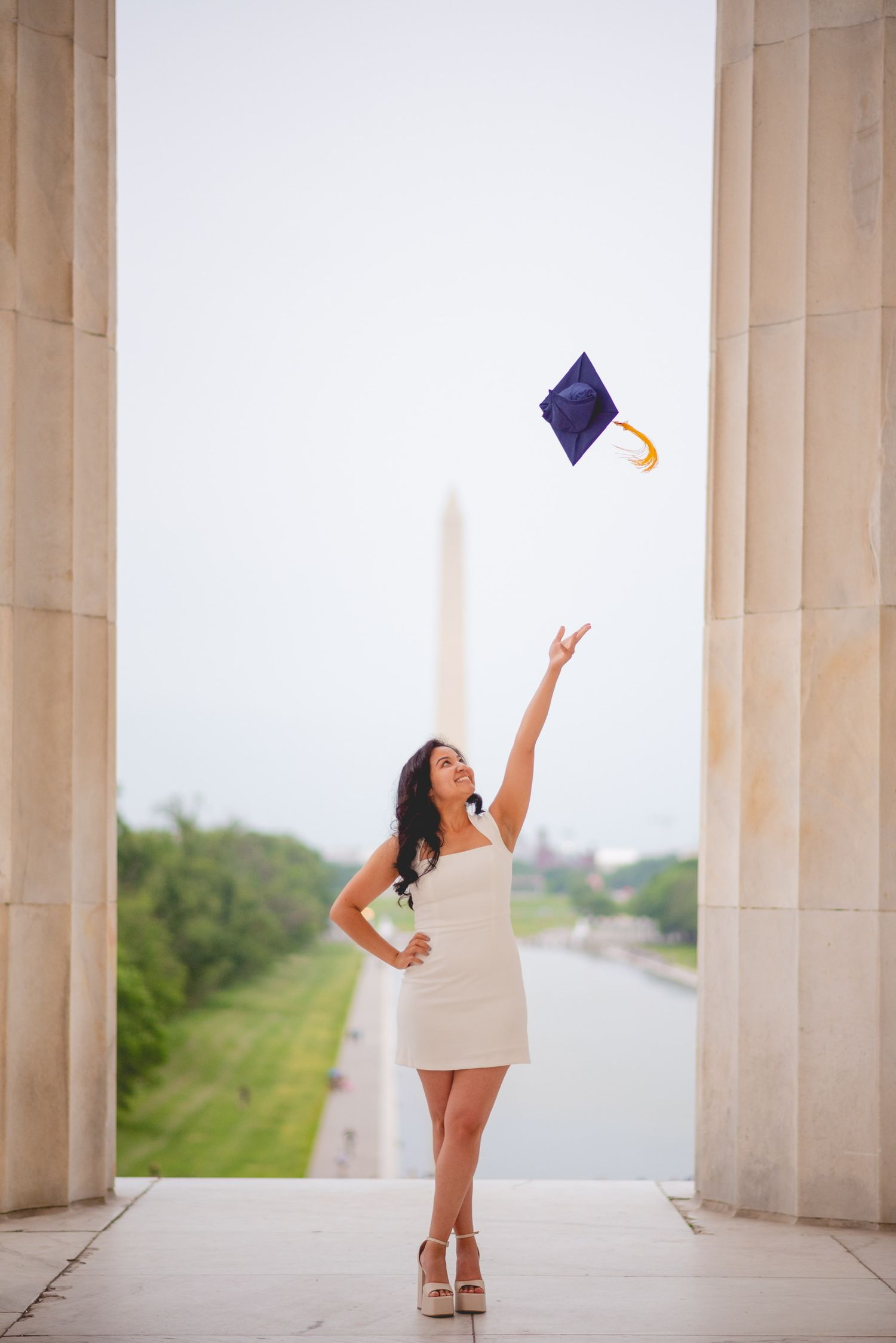 Graduation photo series showing cap toss against classical columned architecture.