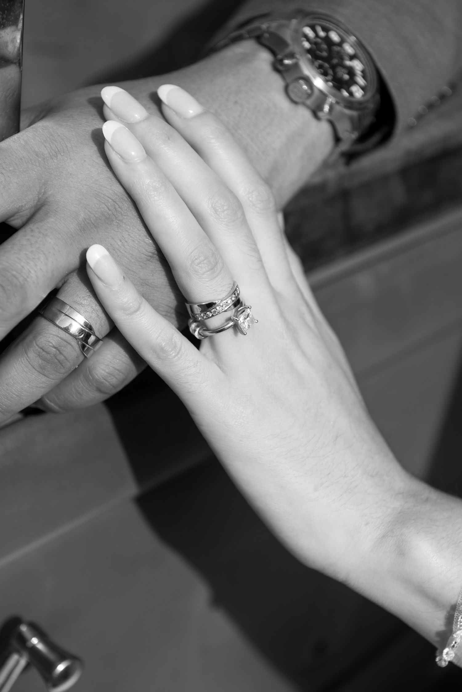 Close-up shots of a sparkling diamond engagement ring on a hand from multiple angles.