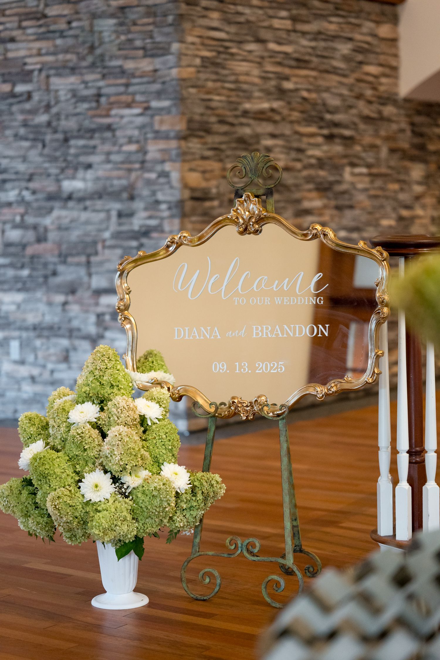 Elegant gold-framed welcome signs with calligraphy text displayed at a wedding reception.